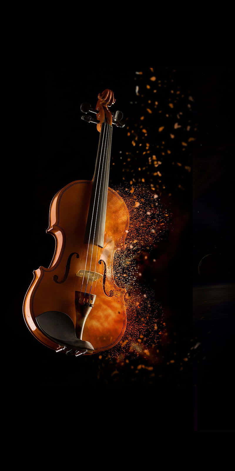 violin 桌布 壁紙 — 一把小提琴在黑色虛空中溫暖地發光，金色粒子從其身體爆炸而出。