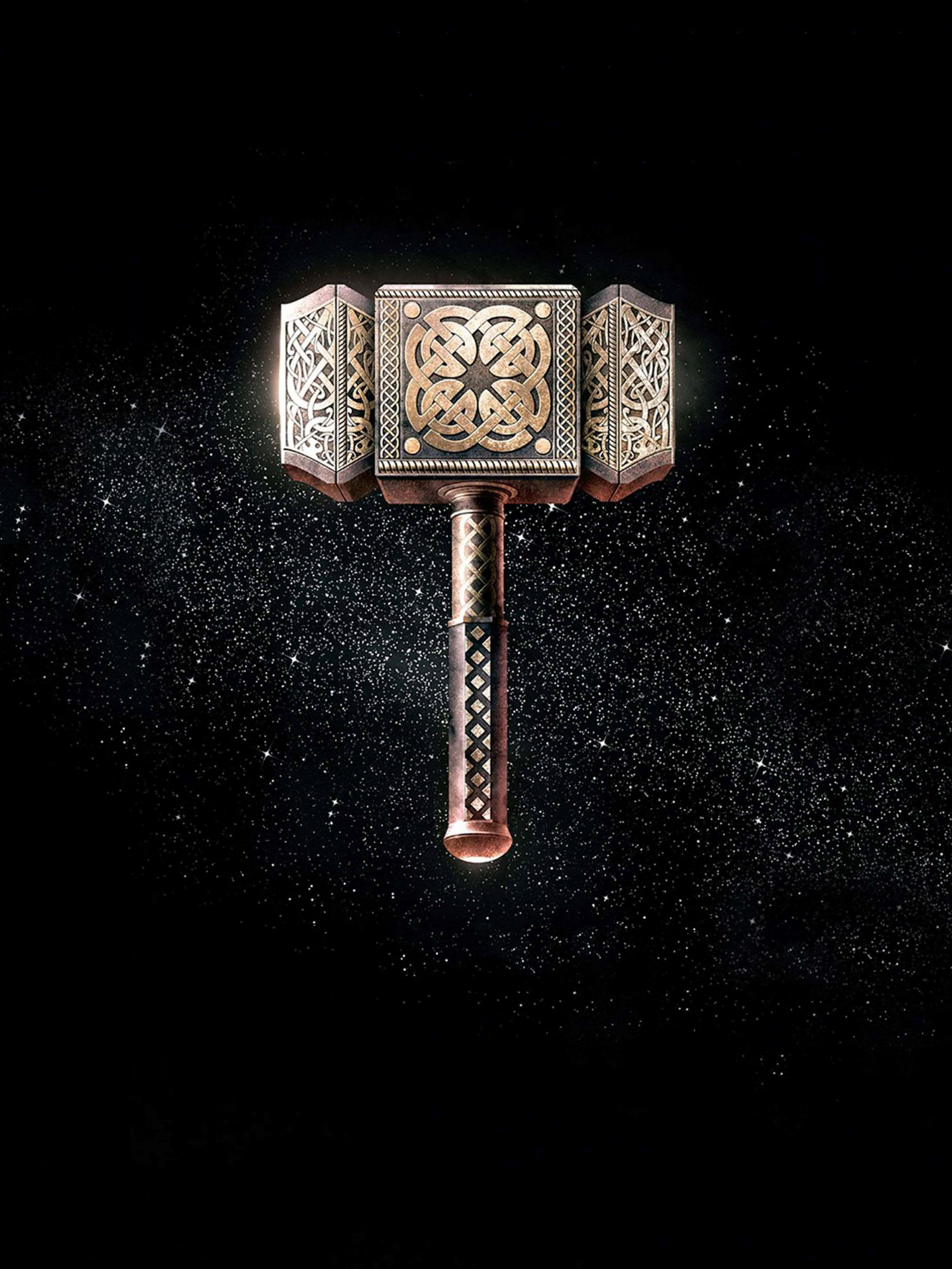 Norse Mythology 桌布 壁紙 — 一把帶有複雜凱爾特圖案、發光的金色錘子漂浮在星空宇宙虛空中。