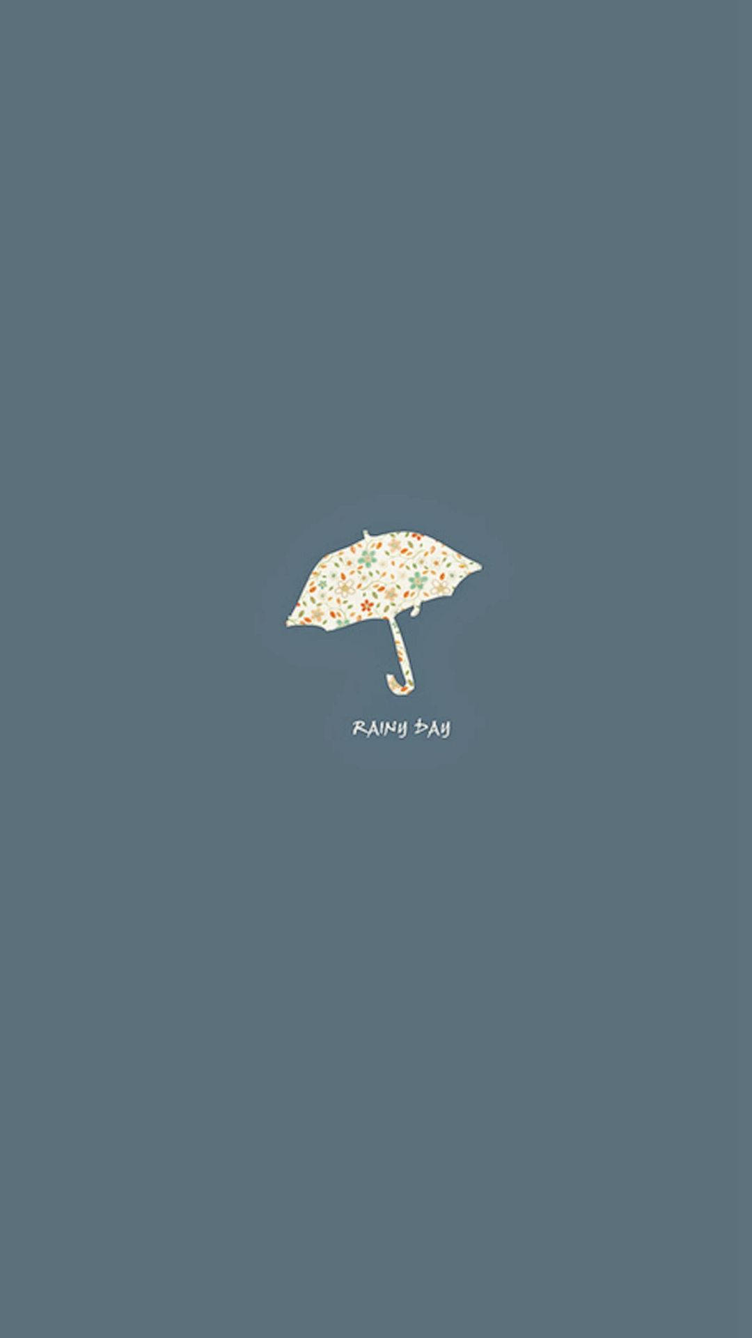 Simple iPhone 桌布 壁紙 — 一把精緻的花卉圖案雨傘獨自漂浮在柔和的藍灰色背景上，下方有「RAINY DAY」字樣。