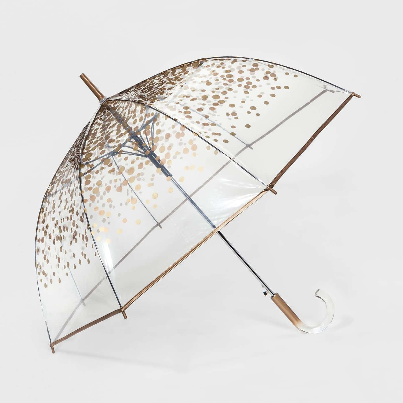 Umbrella 桌布 壁紙 — 一把透明雨傘帶有金色圓點和金屬框架，在純白背景上張開。