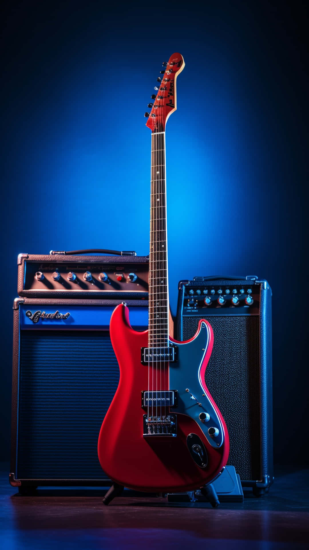 Colorful guitar and sound box wallpaper 壁紙 — 一把鮮紅色的電吉他直立於兩部復古擴音器之間，在戲劇性的藍色舞台燈光下。