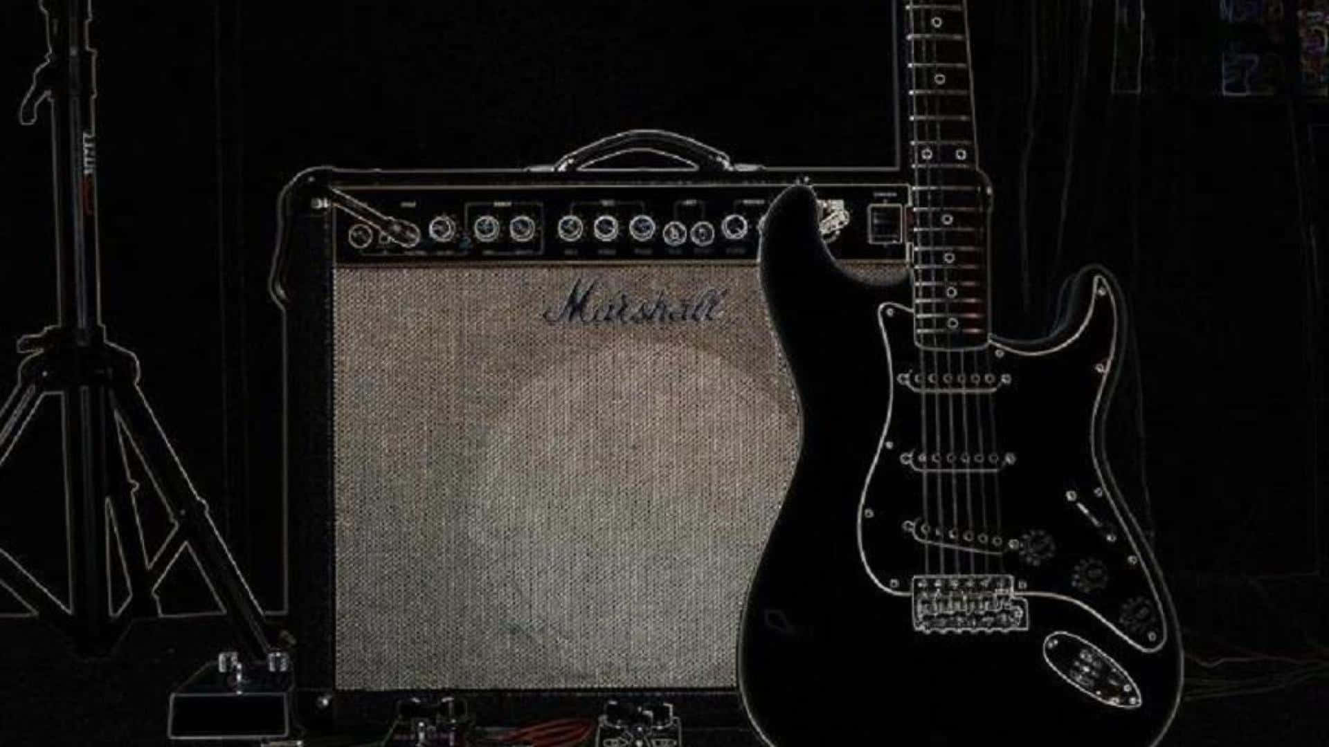 Guitar Amp 桌布 壁紙 — 一把黑色電吉他靠在Marshall音箱上，在昏暗的錄音室中，附近有一個麥克風架。