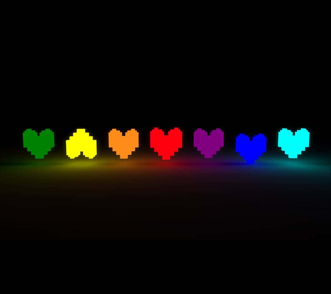 Rainbow Heart 桌布 壁紙 — 一排像素化心形在黑暗背景上發出彩虹色光芒。