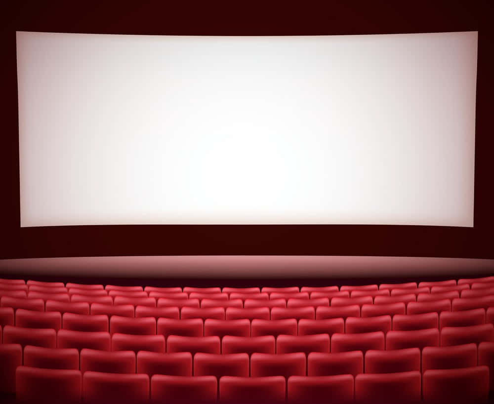 cinema 桌布 壁紙 — 一排排柔軟的紅色戲院座椅面向昏暗劇院中明亮的白色螢幕。