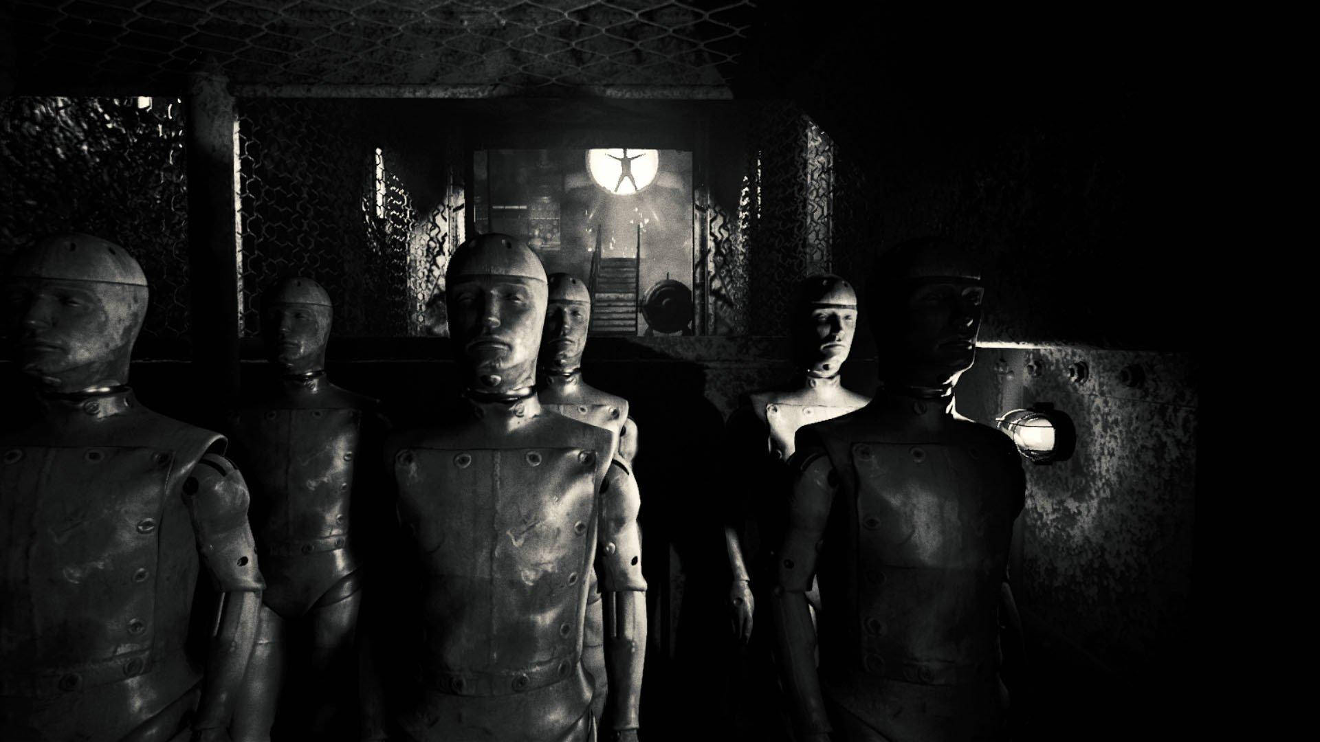 Layers 桌布 壁紙 — 一排金屬人形雕像站在一個光線昏暗的工業房間內，房間有鐵絲網牆和單一頭頂燈。