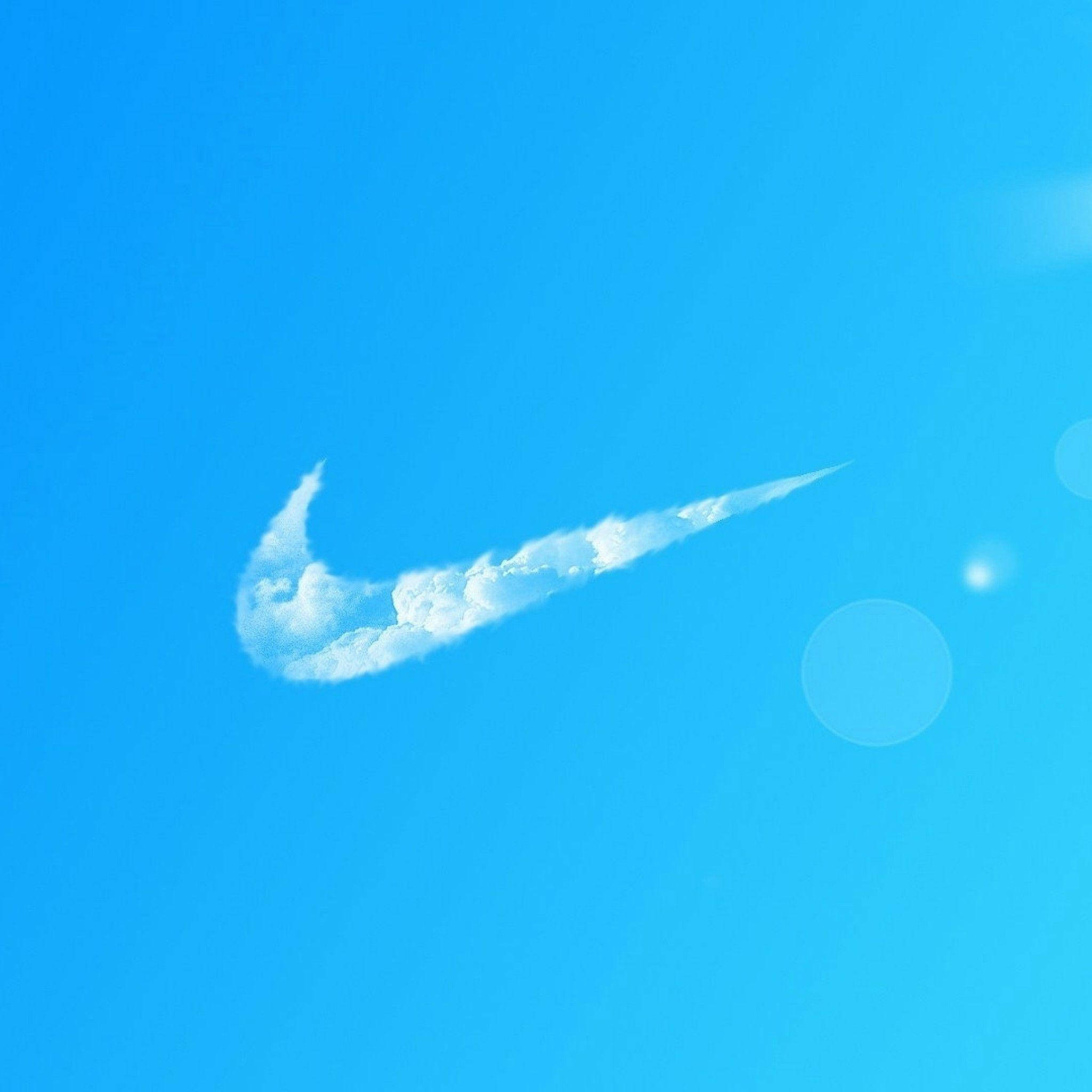 Nike iPhone 桌布 壁紙 — 一朵白色雲朵形狀像Nike勾號，在清澈的藍天中飄浮，帶有柔和鏡頭光暈。