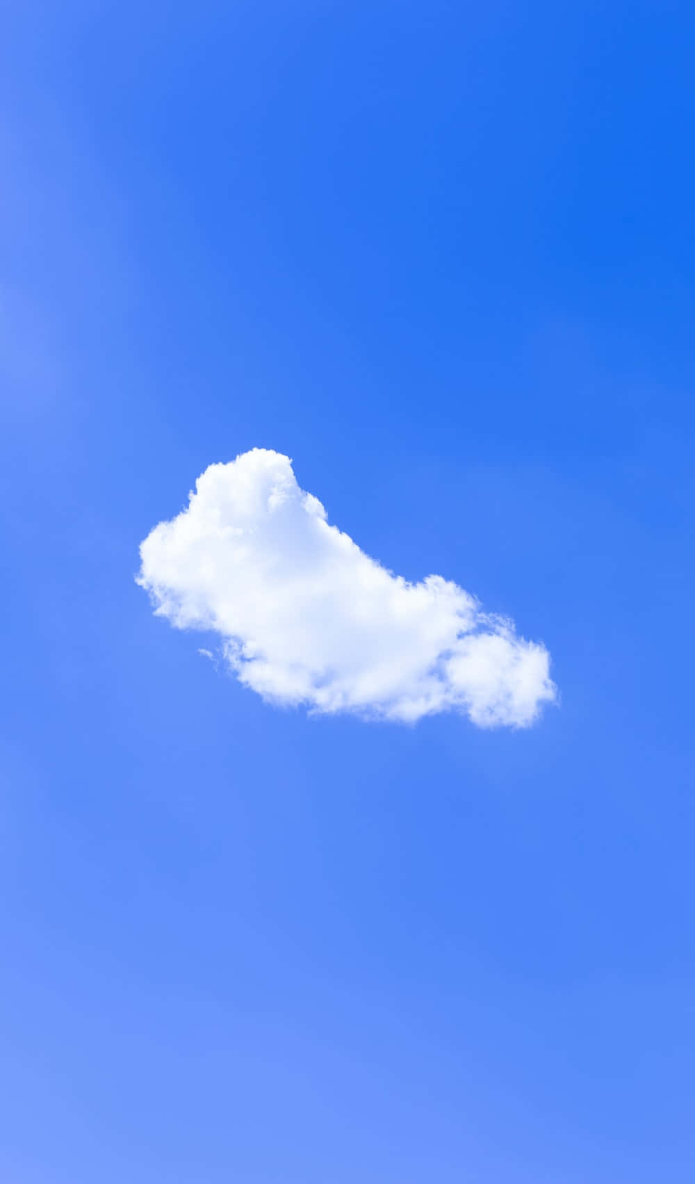 Minimalist Sky 桌布 壁紙 — 一朵蓬鬆的白雲獨自飄浮在廣闊清澈的藍天上。