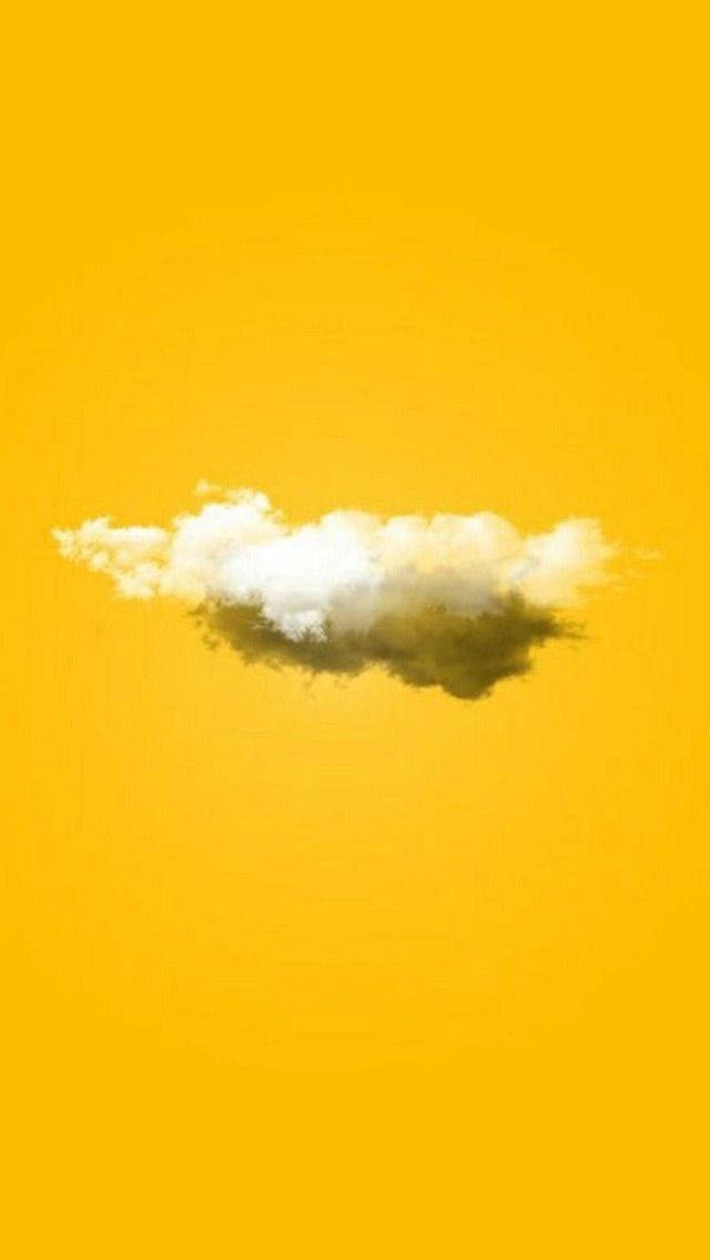 高清 桌布 壁紙 — 一朵蓬鬆的雲朵漂浮在充滿活力的黃色天空中，下方帶有柔和的陰影。