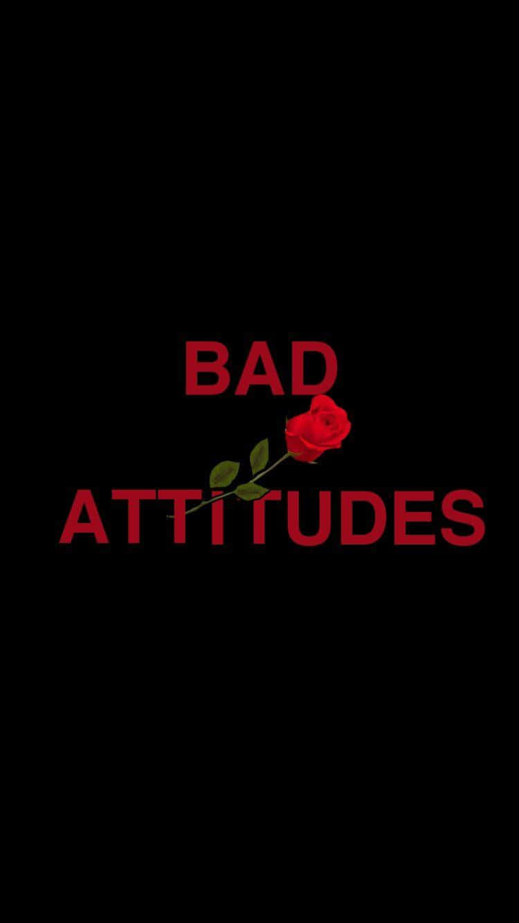 Bad Aesthetic 桌布 壁紙 — 一朵鮮豔的紅玫瑰，帶有綠色莖和葉子，位於黑色背景中央，下方有相同紅色的「BAD ATTITUDES」字樣。