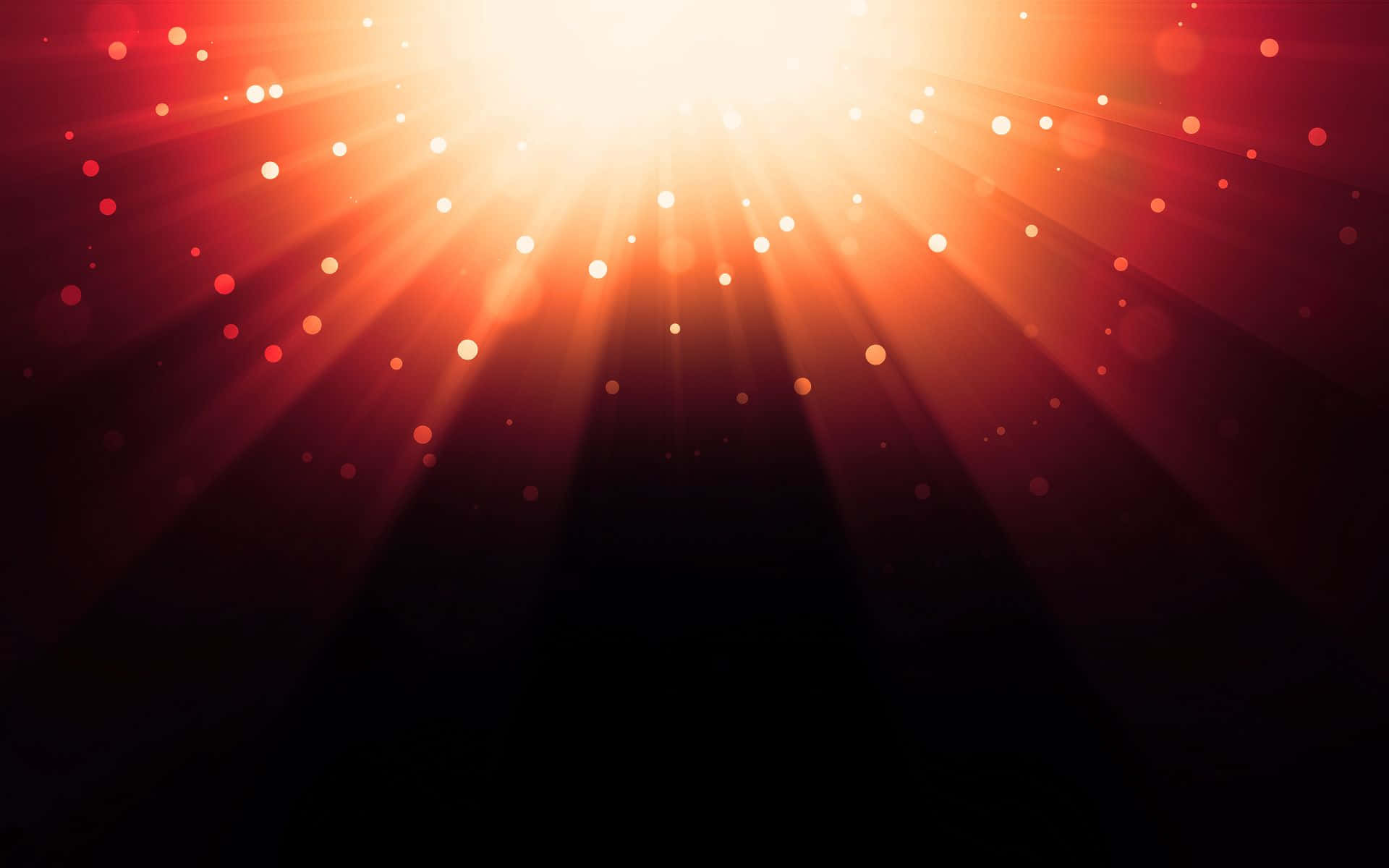 Light Effect 桌布 壁紙 — 一束耀眼的陽光充滿畫面，火紅橙色的光線在黑暗背景中閃爍著發光的球體。