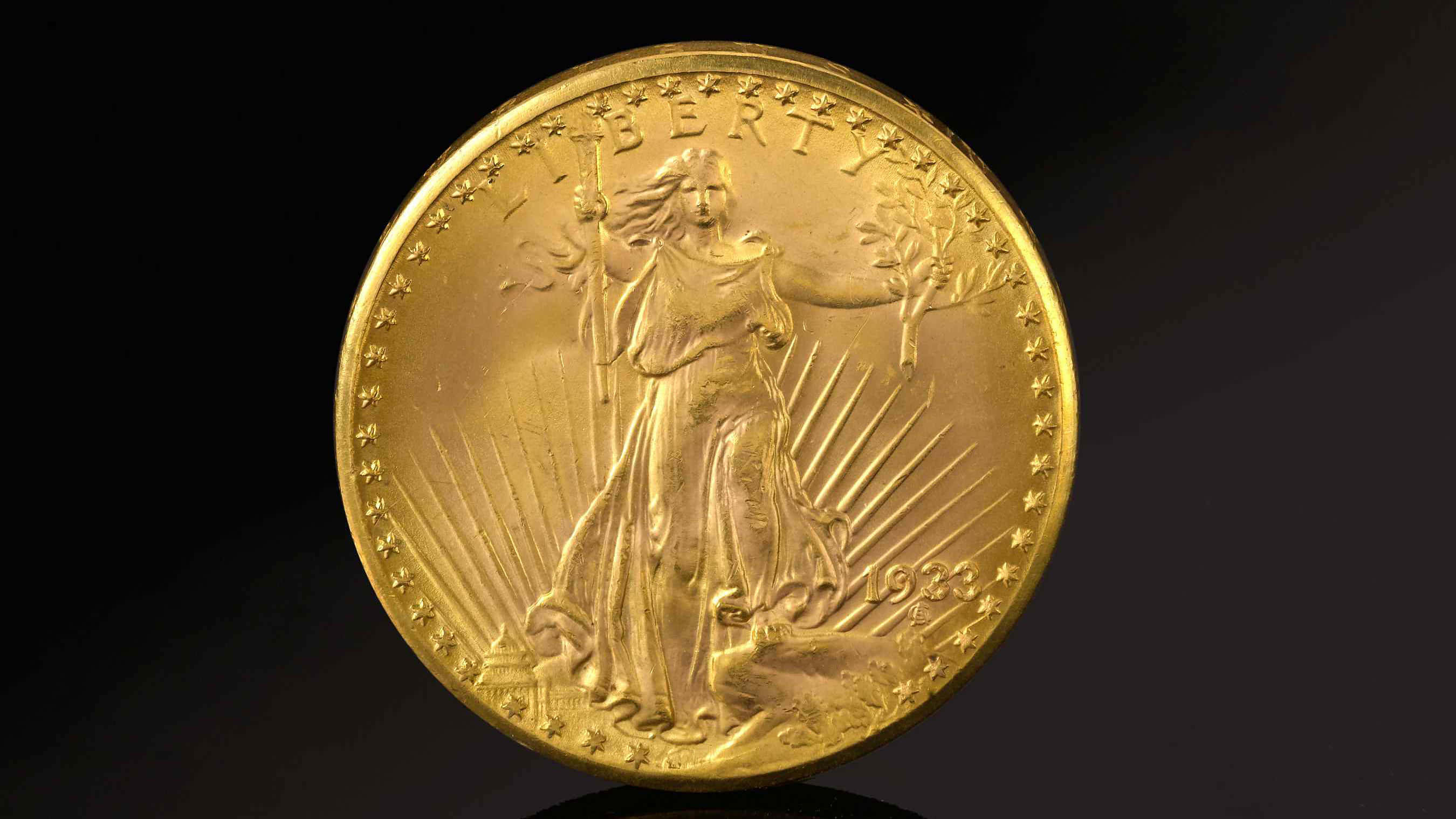 Coin 桌布 壁紙 — 一枚閃閃發光的1923年金鷹硬幣，自由女神手持橄欖枝和火炬，在黑暗背景下散發出陽光。