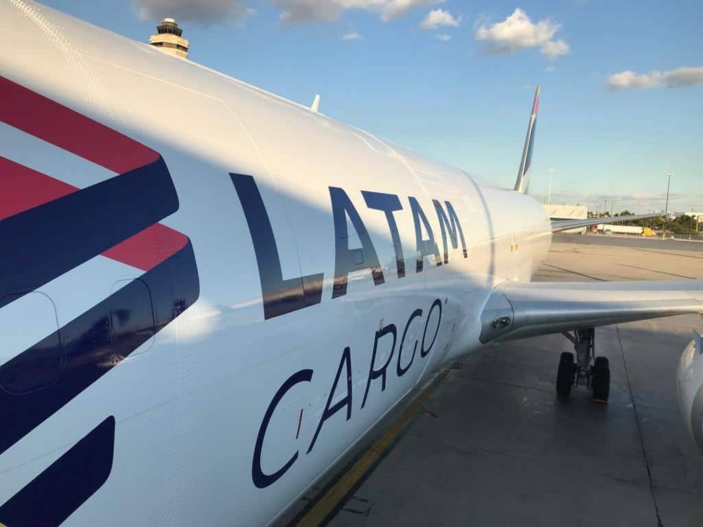 Airport 桌布 壁紙 — 一架LATAM Cargo飛機停泊在機場停機坪上，天空局部多雲，溫暖的金色光線照耀。