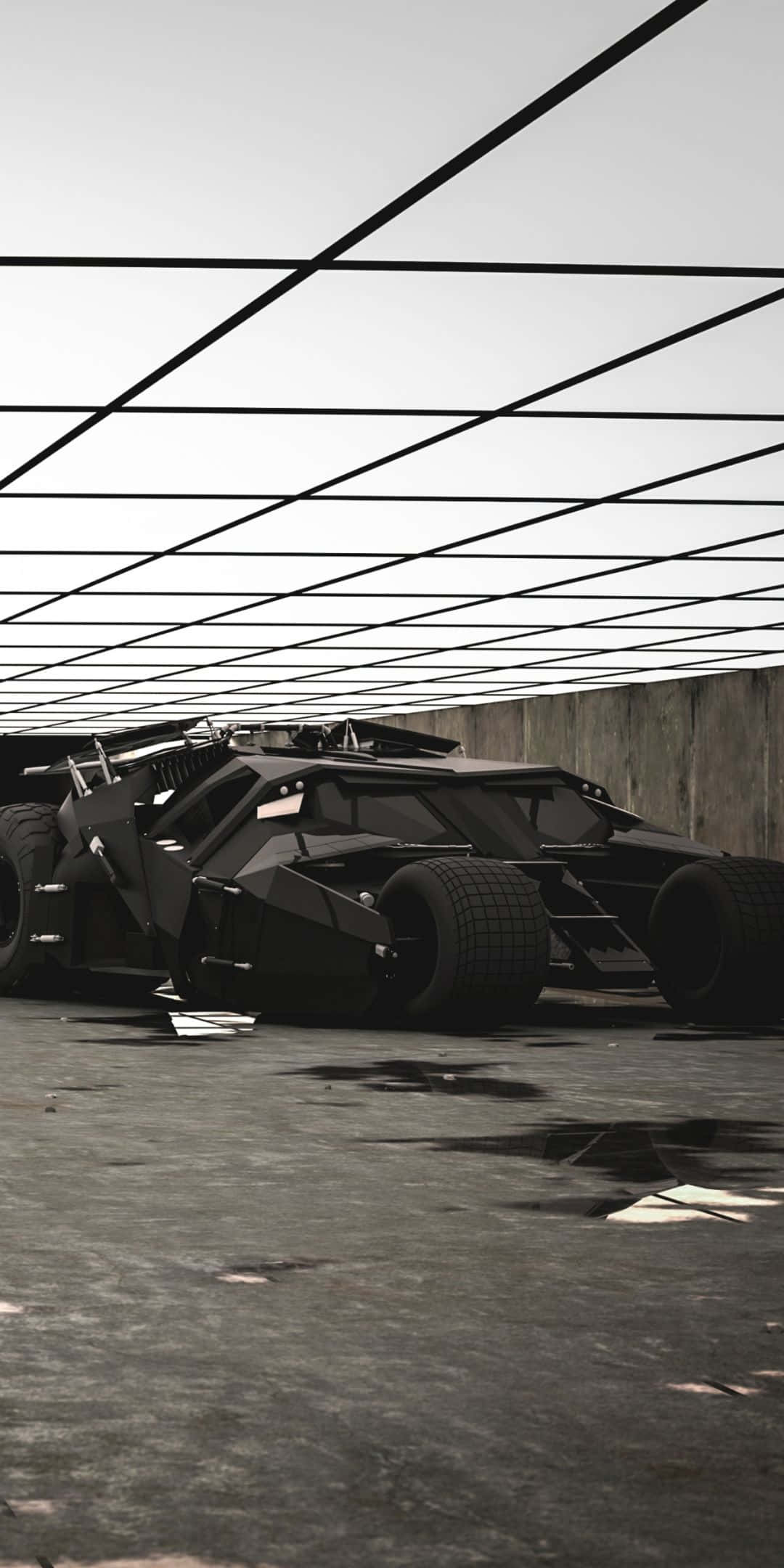 Pixel 3 Batmobile 桌布 壁紙 — 一架具威脅性的黑色裝甲車停放在粗糙混凝土車庫的架空橫樑網格下。
