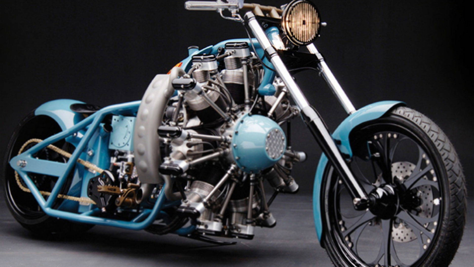 Choppers 桌布 壁紙 — 一架客製藍色chopper機車，配備外露引擎和鍍鉻細節，在深色攝影棚背景前擺姿勢。