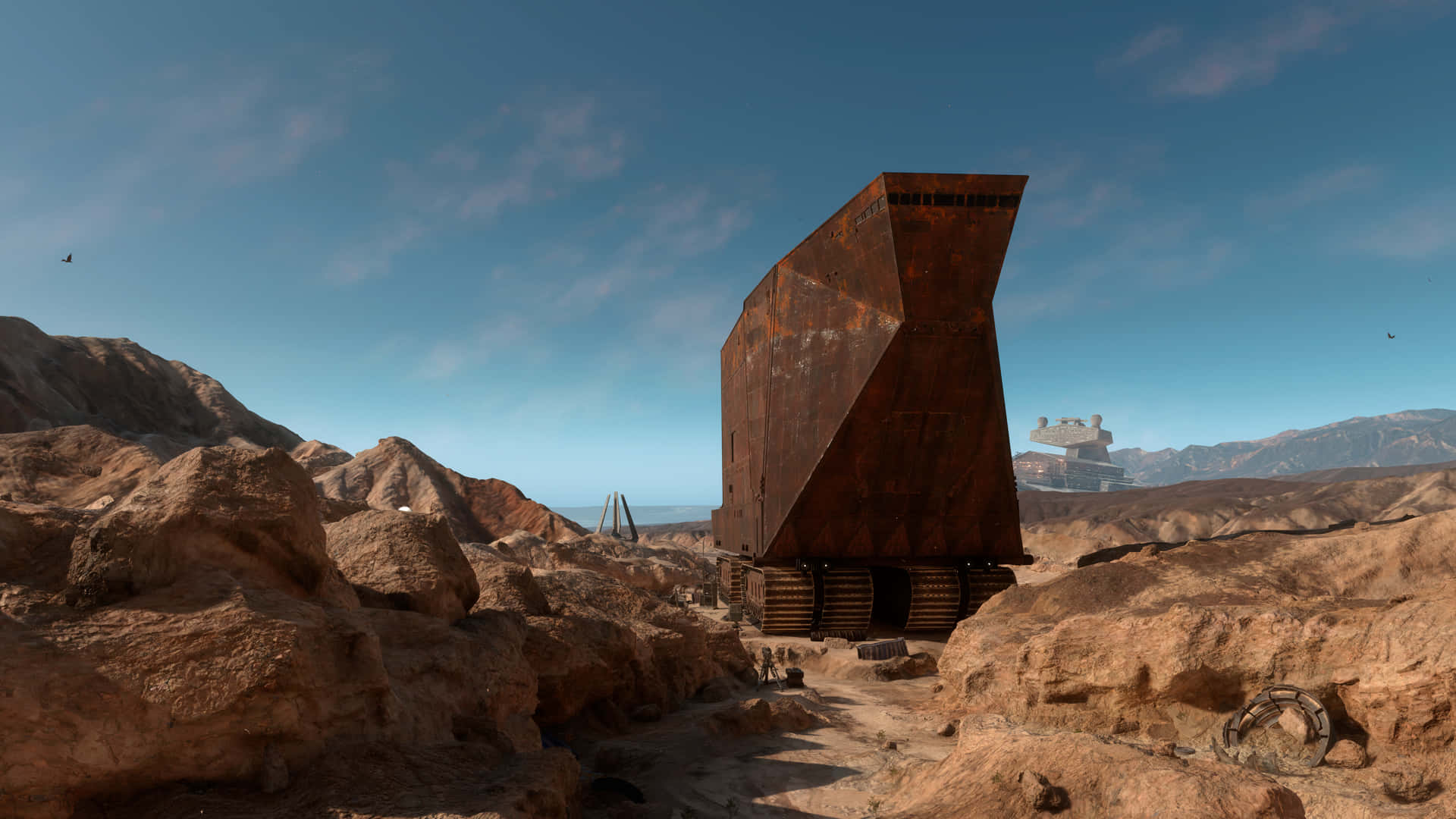 Tatooine 桌布 壁紙 — 一架巨大的生鏽AT-AT步行機矗立在荒蕪的沙漠景觀中，背景是清澈的藍天和遠山。