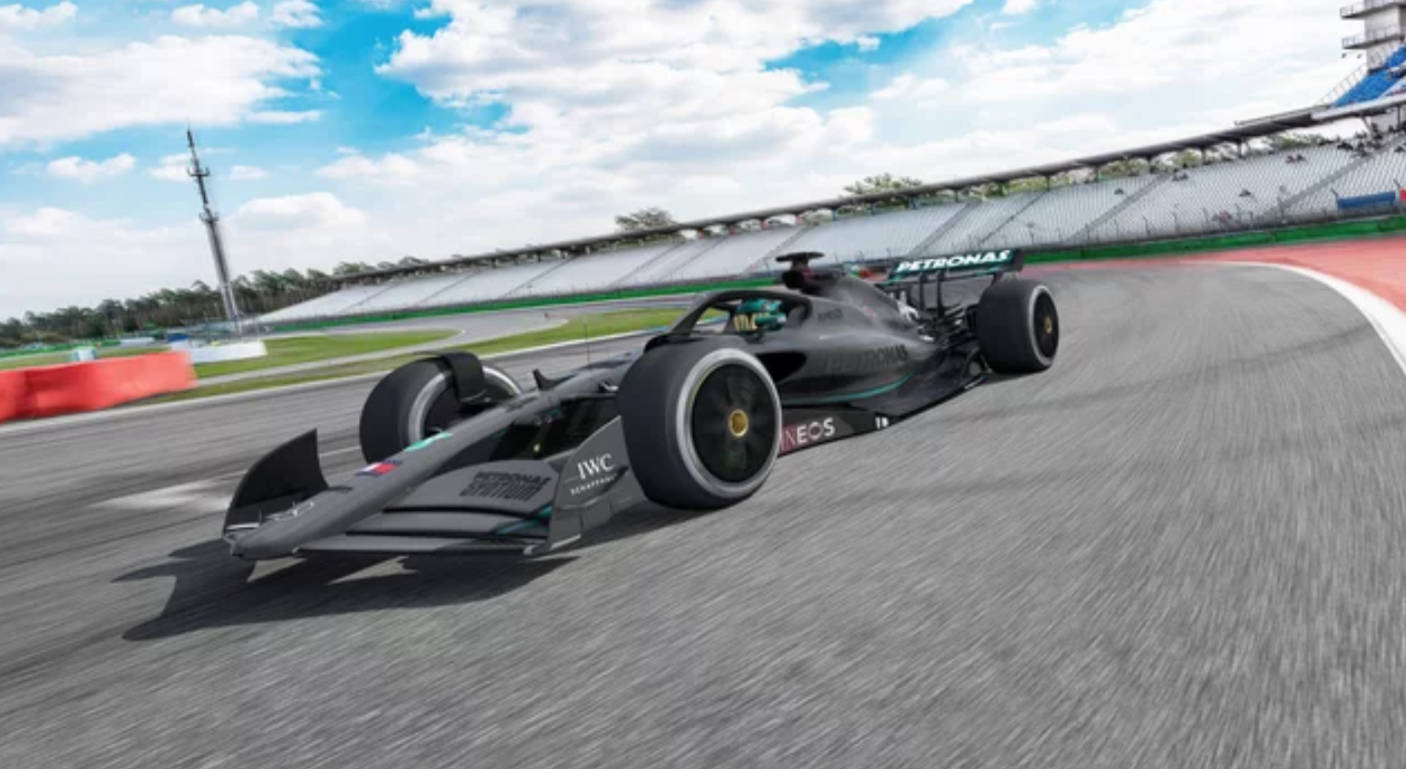4K 桌布 壁紙 — 一架帶有Petronas標誌的時尚黑色一級方程式賽車，在藍天白雲下沿著彎曲的瀝青賽道奔馳。