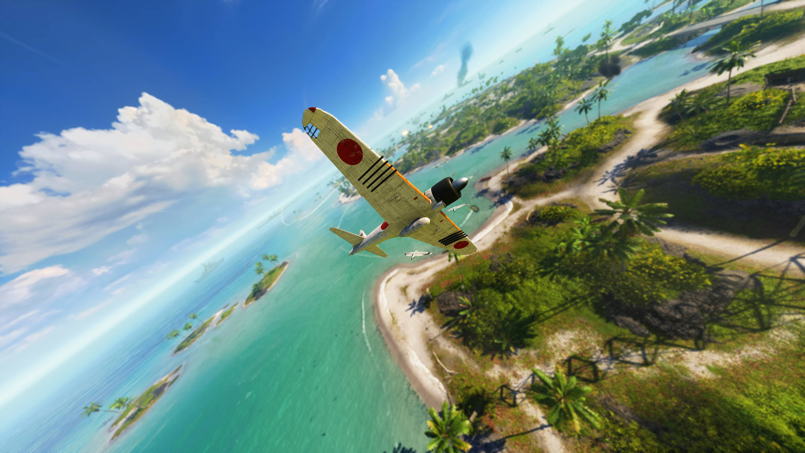 Battlefield 5 桌布 壁紙 — 一架復古日本戰鬥機在明亮的藍天下低飛過一個擁有碧綠海水和棕櫚樹的熱帶島嶼。