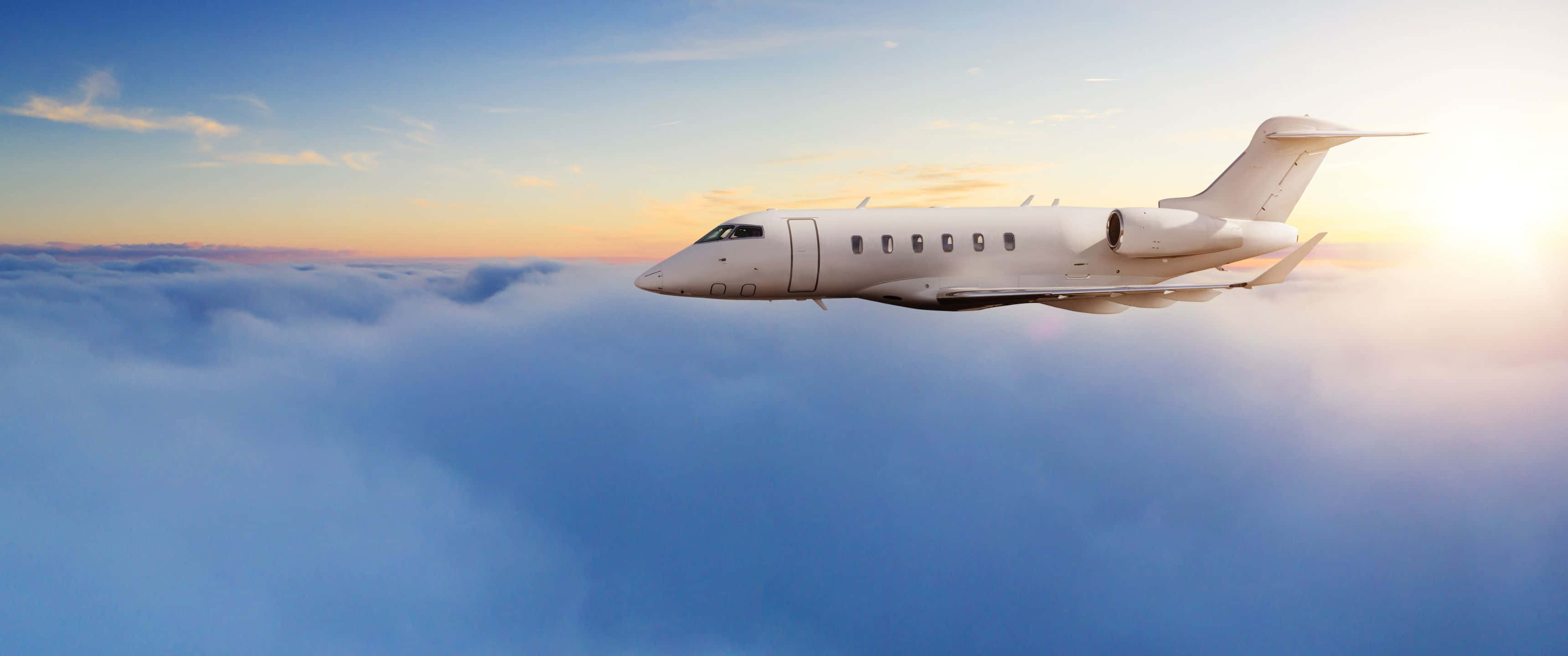 3440x1440p Small Planes 桌布 壁紙 — 一架時尚的白色私人飛機在金色日出時翱翔於雲海之上。