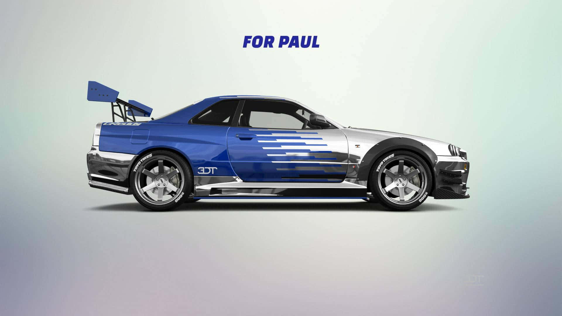 Paul Walker Skyline 桌布 壁紙 — 一架時尚的藍銀色跑車，帶有大型尾翼和賽車條紋，置於攝影棚環境中。