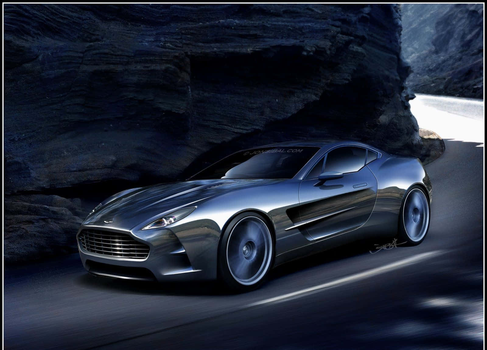 Aston Martin One-77 桌布 壁紙 — 一架時尚的銀色跑車在黑暗的岩石隧道中高速行駛，道路上呈現動態模糊效果。