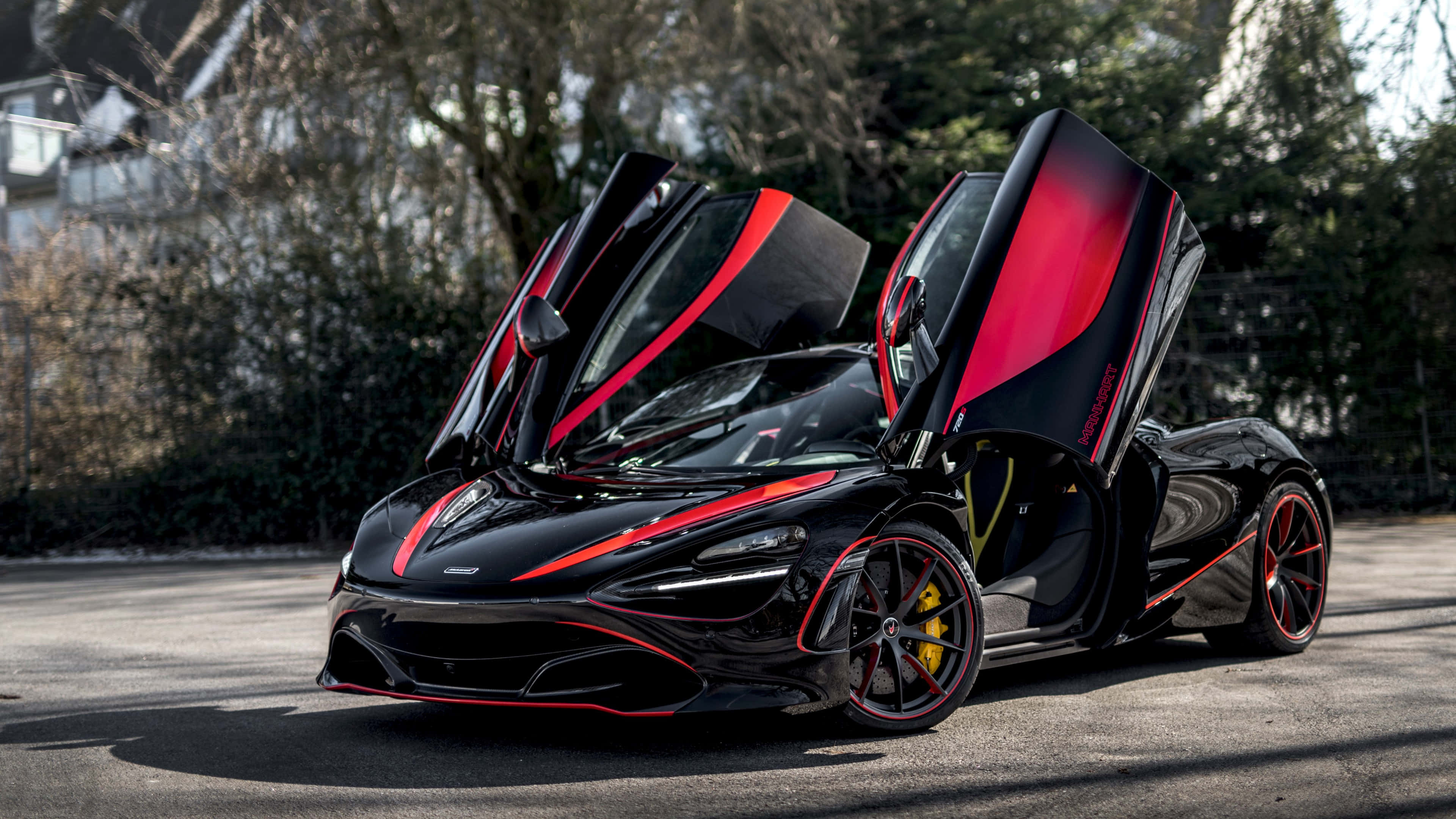 4K Mclaren 720s 桌布 壁紙 — 一架時尚的黑色McLaren跑車，帶有紅色點綴和打開的蝴蝶門，停泊在陽光明媚的街道上。