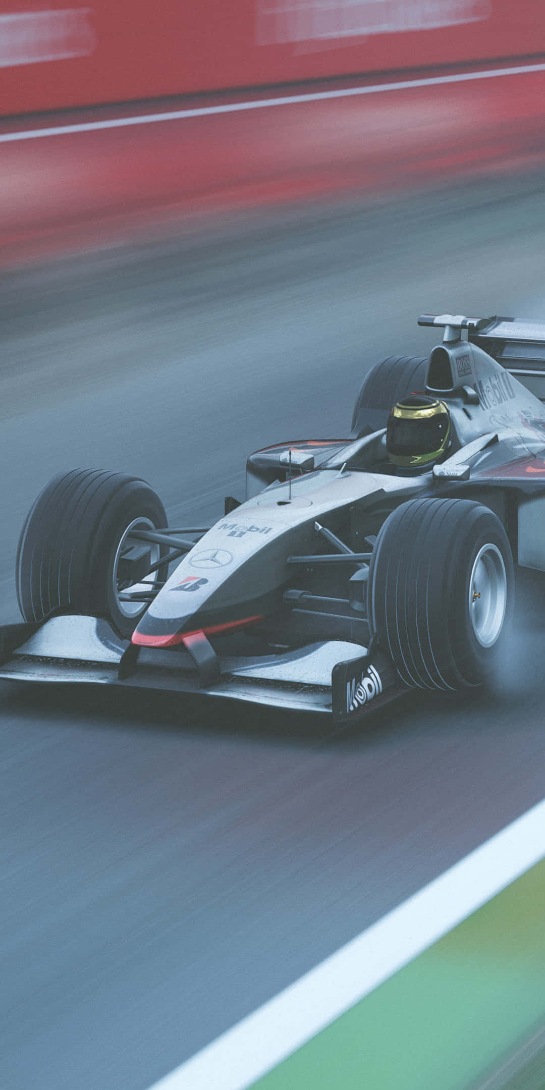 F1 桌布 壁紙 — 一架流線型銀色一級方程式賽車在模糊的紅綠背景中高速馳騁。