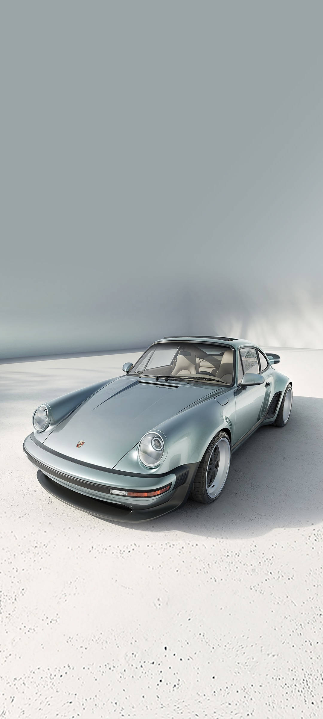 簡約工作室環境中，白色混凝土上的銀色保時捷911 Turbo。 — 保時捷 GIF 壁紙