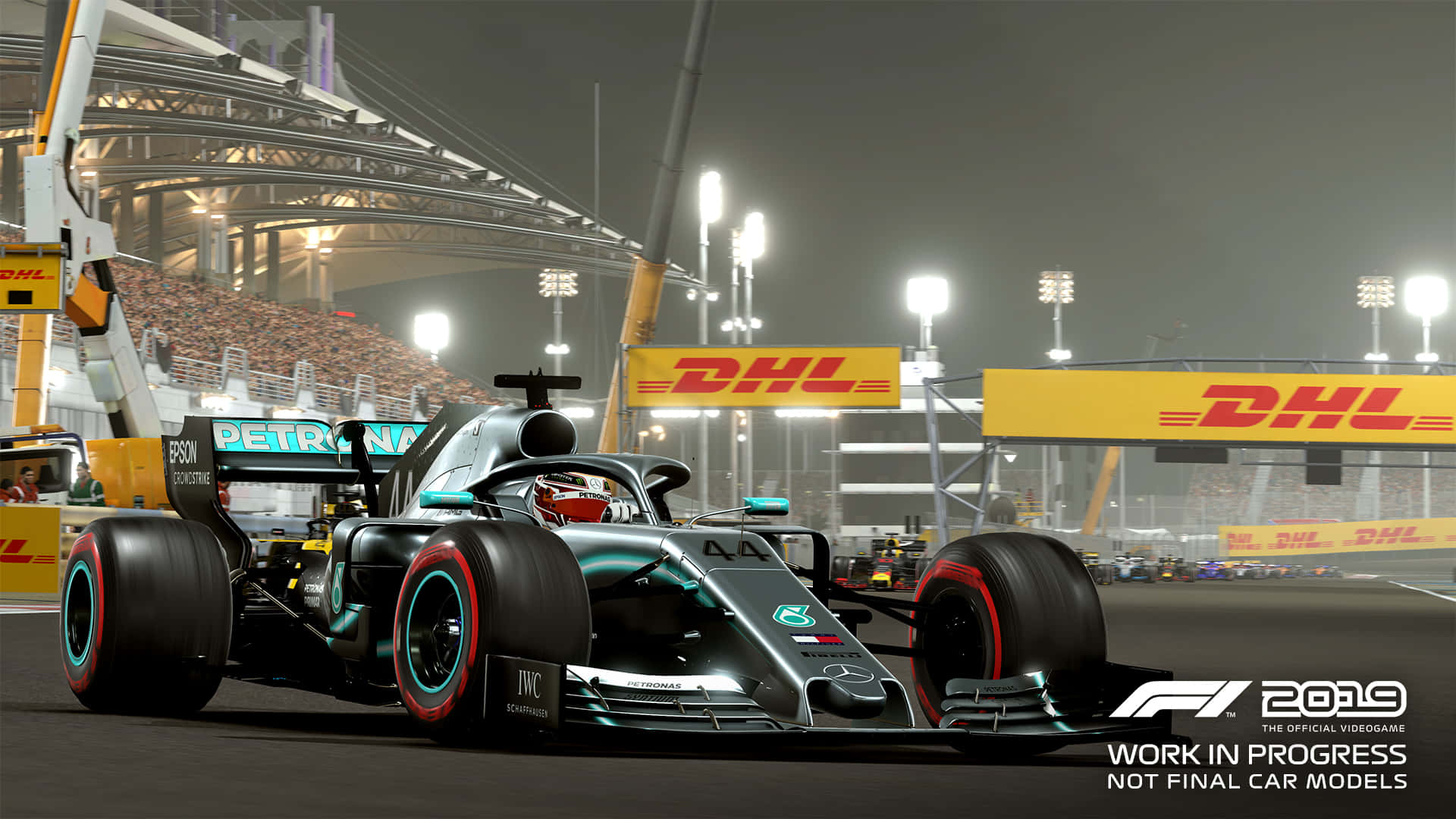 Race Track 桌布 壁紙 — 一架流線型銀色和藍綠色的F1賽車在夜間明亮的體育場燈光下奔馳，看台座無虛席，還有DHL橫幅。