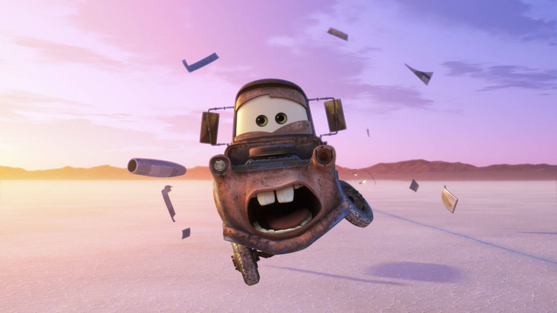 Animation 桌布 壁紙 — 一架生鏽的動畫拖車咧嘴笑著，在日落時分飛過沙漠，周圍散落著碎片。