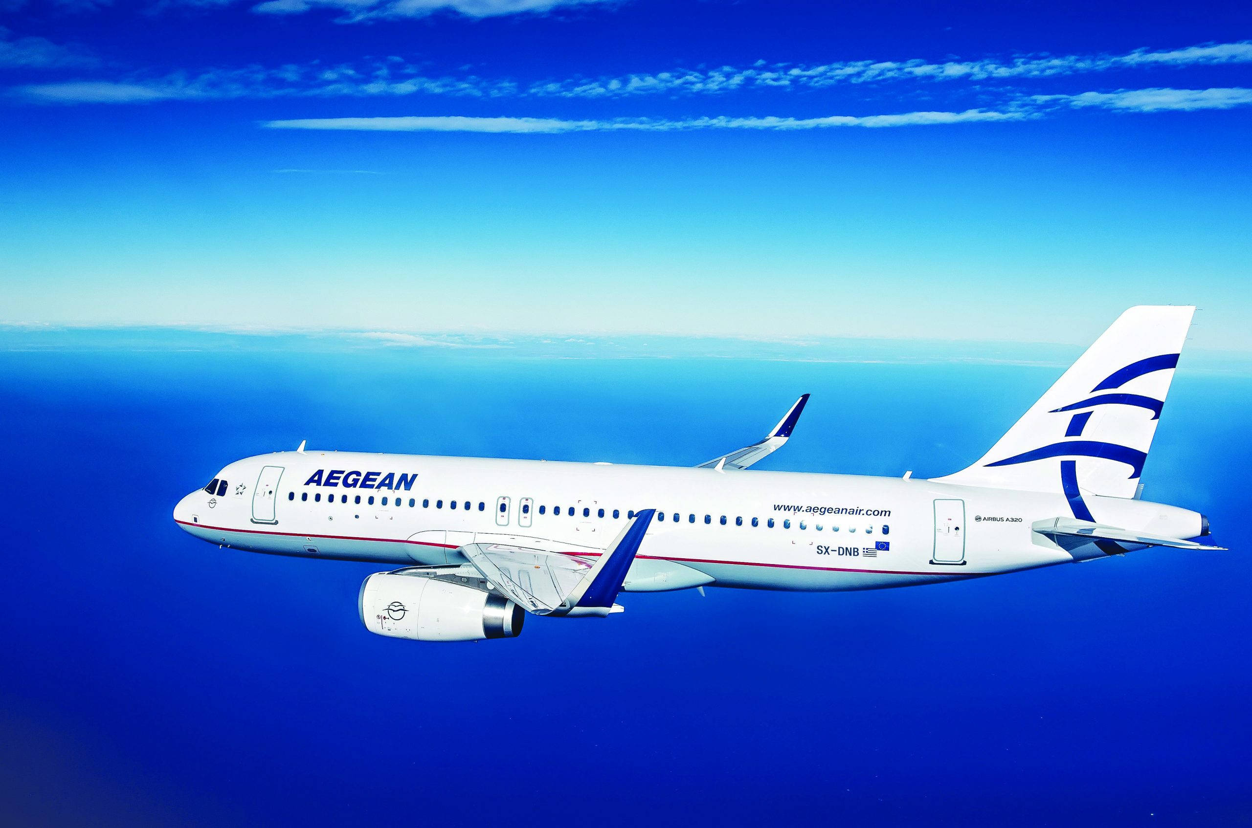 Plane 桌布 壁紙 — 一架白色的愛琴海航空飛機在晴朗的天空下，伴隨著縷縷白雲，優雅地翱翔在無盡的藍色海洋之上。