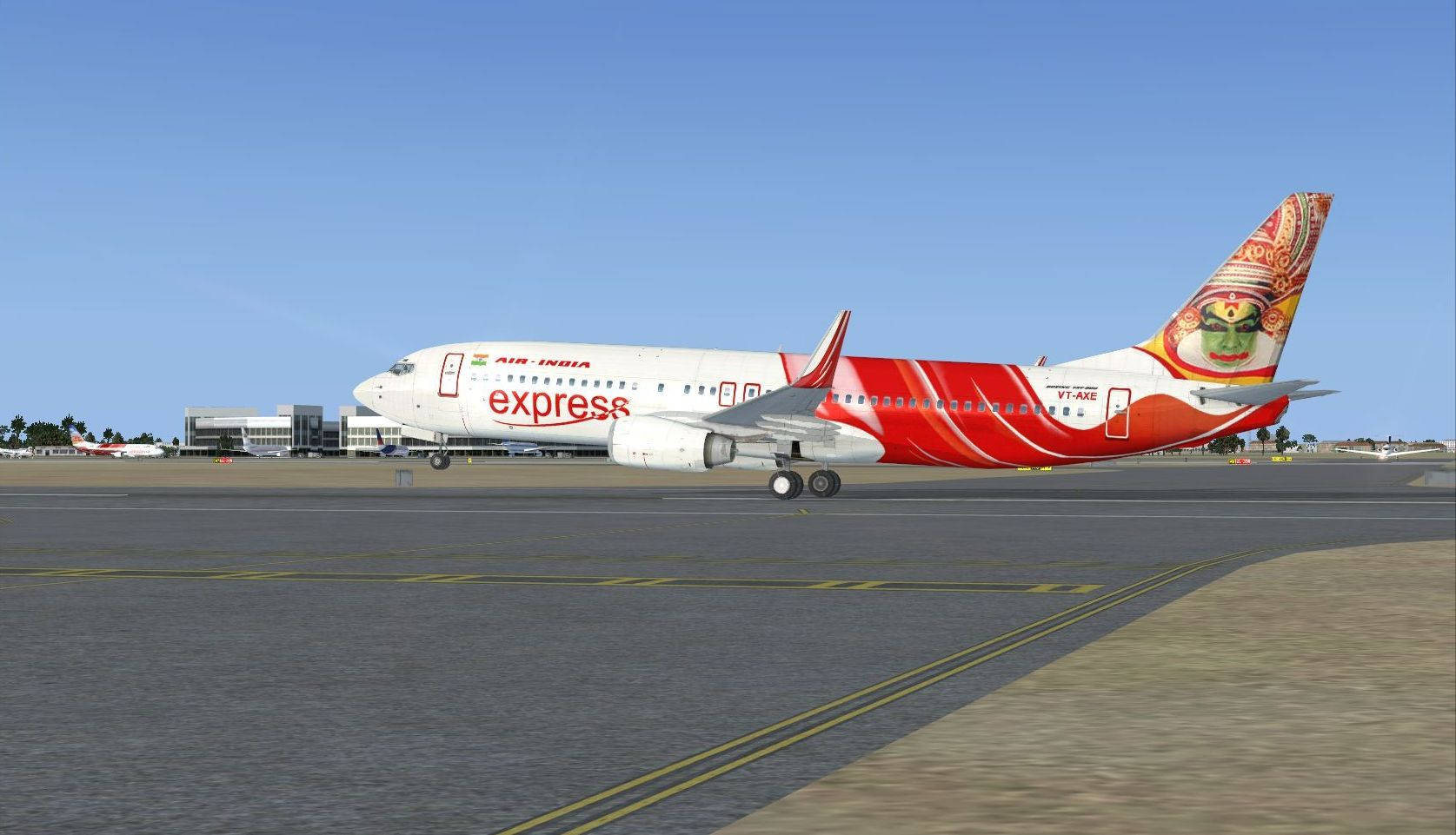  壁紙 — 一架紅白塗裝的印度航空快運波音737在晴朗的藍天下於陽光普照的機場停機坪滑行。