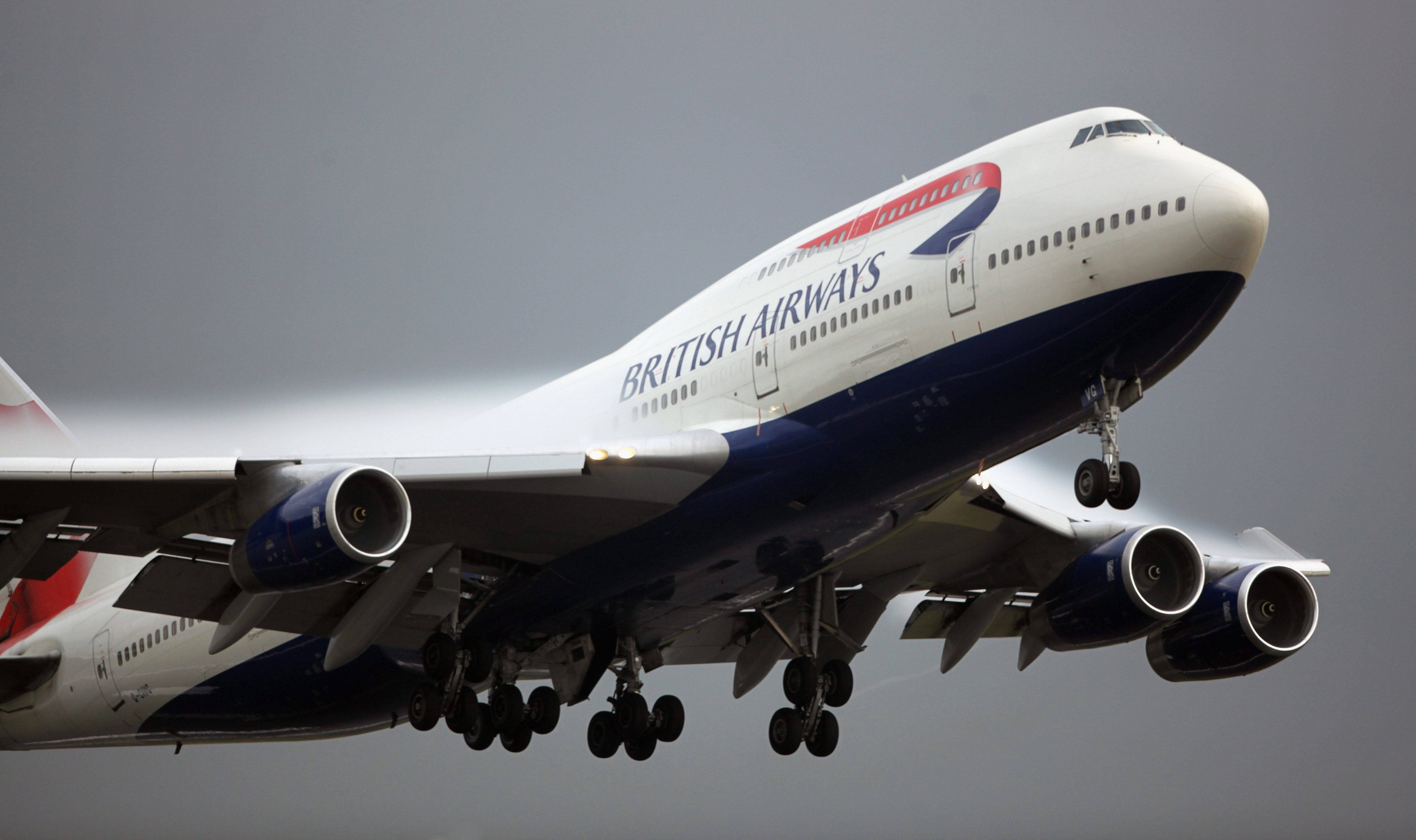 Plane 桌布 壁紙 — 一架英國航空波音747正在灰色多雲的天空中放下起落架下降。