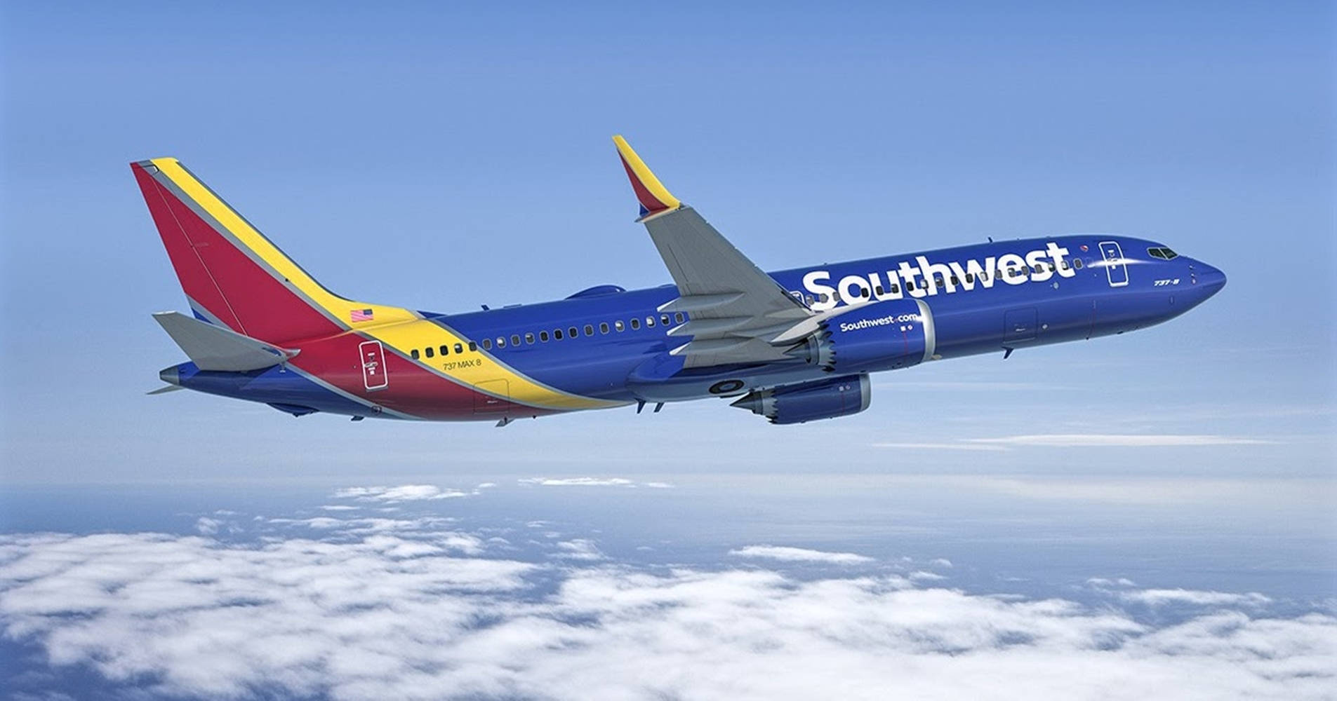 飛機 桌布 壁紙 — 一架西南航空的波音737在晴朗藍天下翱翔於蓬鬆白雲之上。