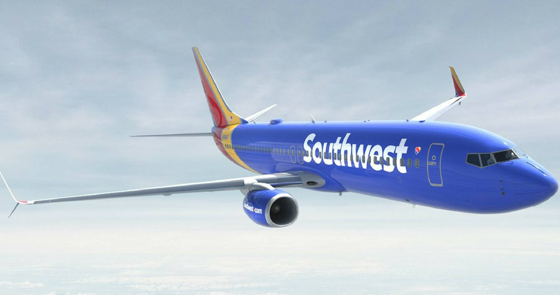  壁紙 — 一架西南航空的波音737在雲霧繚繞的天空中翱翔，下方是白雲的海洋。