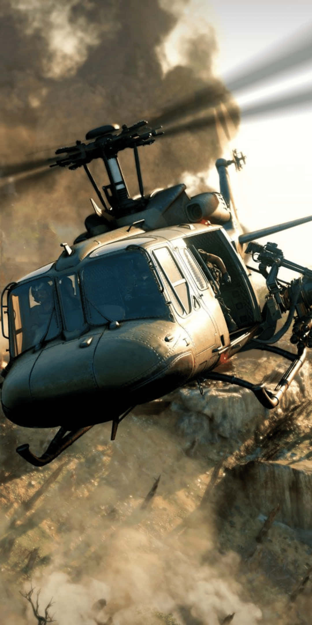 Helicopter 桌布 壁紙 — 一架軍用直升機低飛越過塵土飛揚的戰場，背後有煙霧升起。