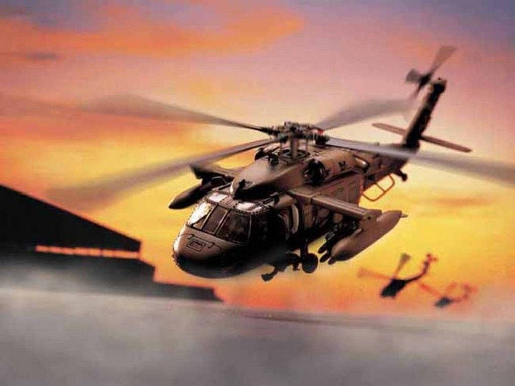 Black Hawk Helicopter 桌布 壁紙 — 一架軍用直升機在火紅的日落天空中翱翔，遠處可見另一架直升機。