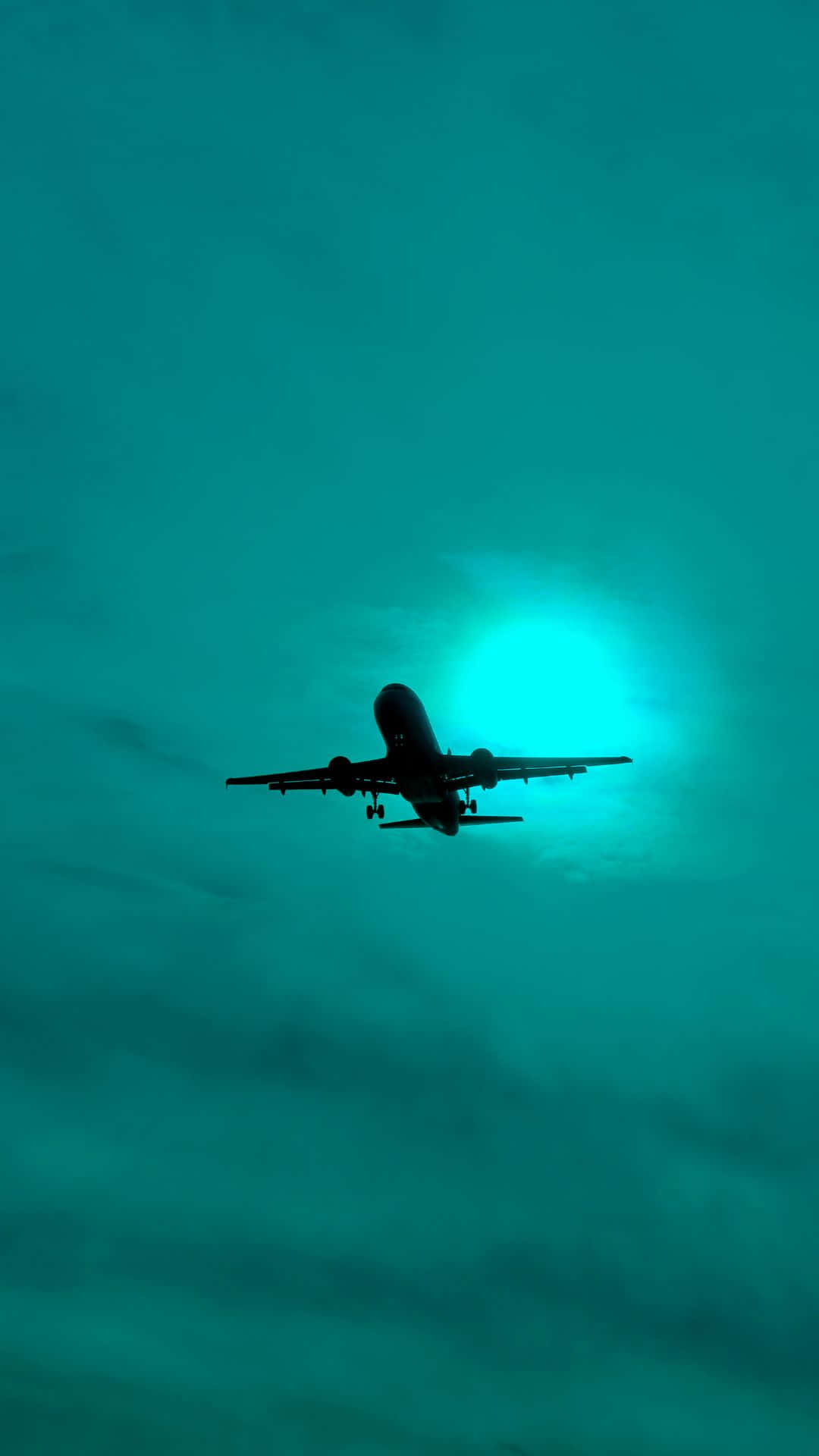 飛機剪影在發光的藍綠色天空中飛行 — 飛機 壁紙