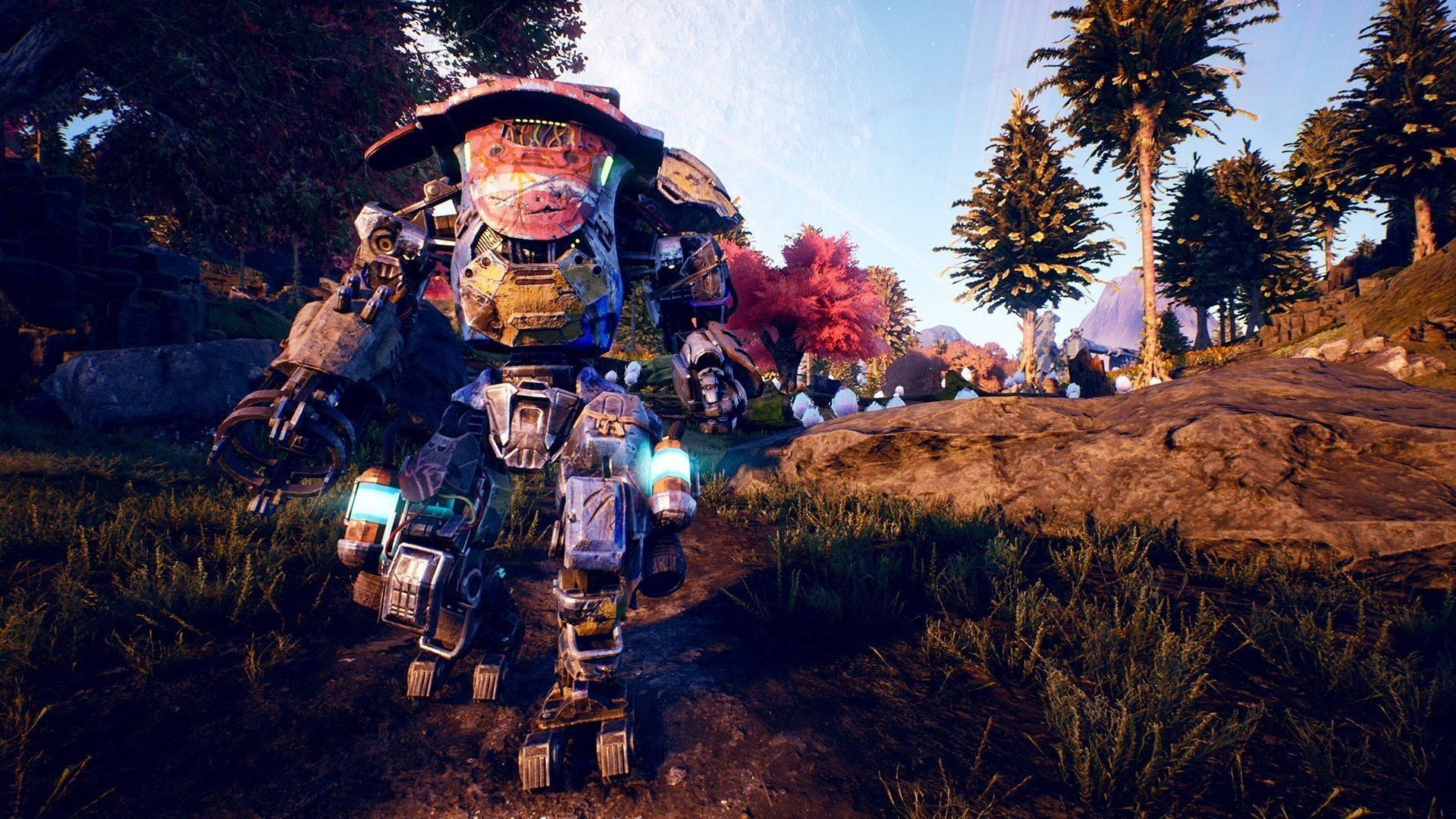 The Outer Worlds 桌布 壁紙 — 一架高聳的裝甲機甲，帶有發光的藍色燈光，站在陽光明媚的森林空地中，有紅色的樹木和遠山。