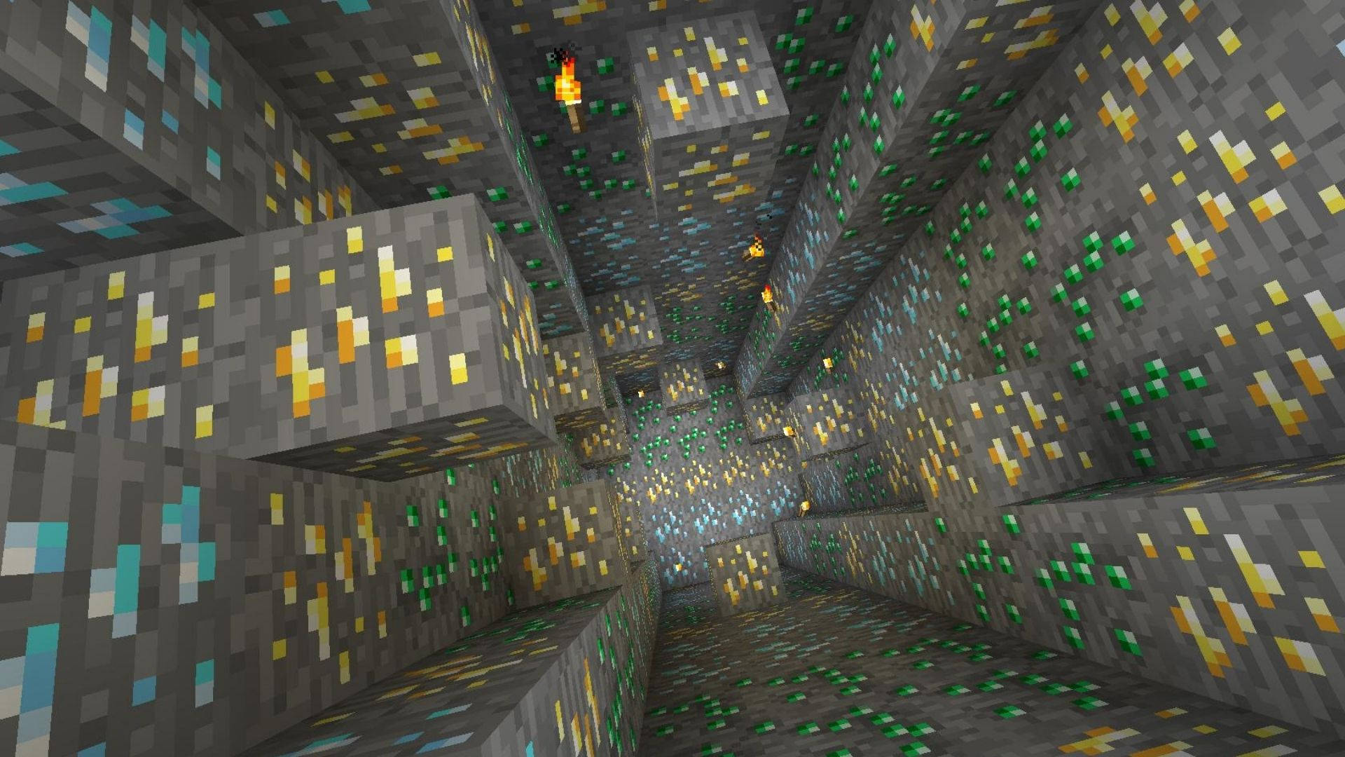 我的世界 鑽石 桌布 壁紙 — 一條像素化的Minecraft礦井隧道，在火炬光照下排列著發光的綠色和黃色礦石。