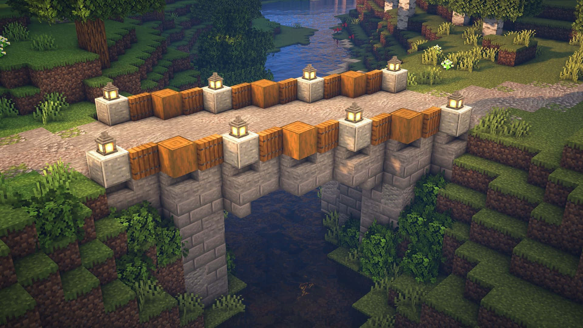 Minecraft Bridges 桌布 壁紙 — 一條像素化的石橋，帶有木欄杆和發光燈籠，橫跨在一個方塊狀Minecraft景觀中的河流上。