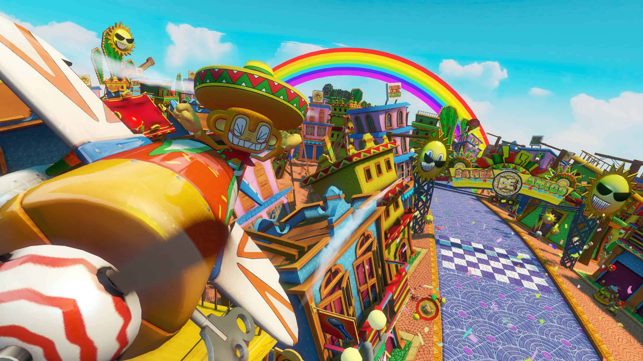 Sonic And All-stars Racing Transformed 桌布 壁紙 — 一條充滿活力的卡通賽道，有一隻戴著墨西哥闊邊帽的巨大微笑猴子，彩虹拱在色彩繽紛的建築物上。