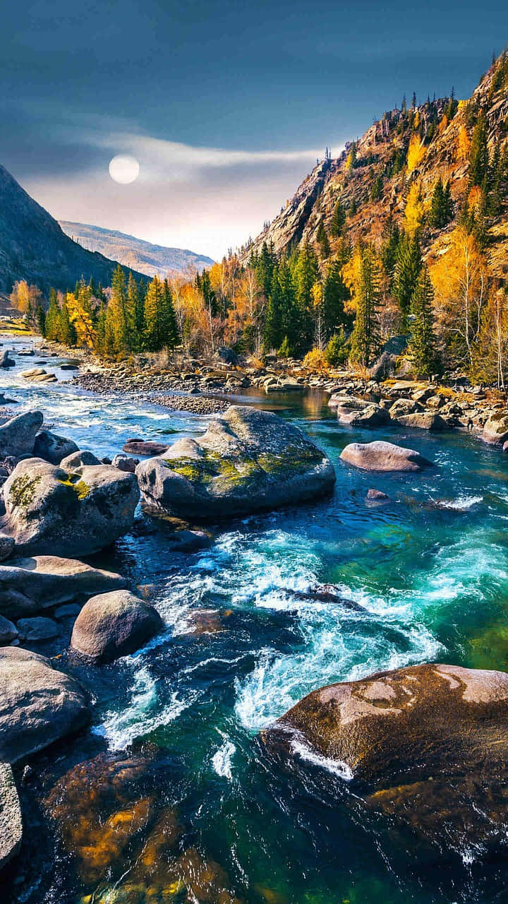 山景 桌布 壁紙 — 一條充滿活力的河流在明亮的月光下，流過長滿青苔的岩石，穿過森林覆蓋的山谷。