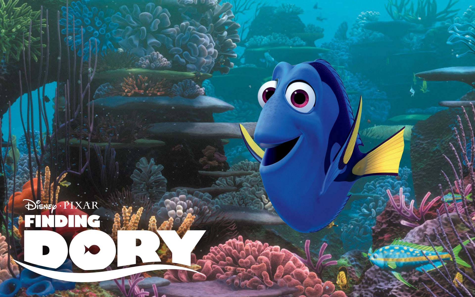 Dory 桌布 壁紙 — 一條充滿活力的藍色魚，黃色魚鰭，快樂地游過一個色彩繽紛的珊瑚礁，充滿熱帶魚和海草。