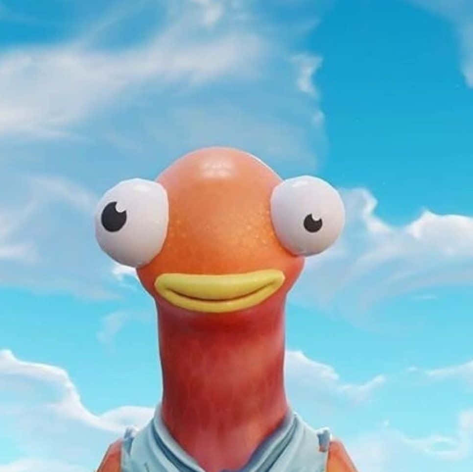 Fortnite 桌布 壁紙 — 一條卡通橙色魚，有大白色眼睛和黃色笑容，站在有 fluffy 雲朵的明亮藍天下。