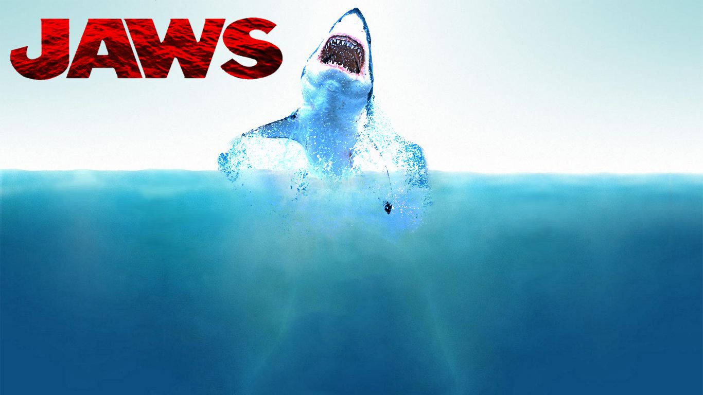 Jaws 桌布 壁紙 — 一條大白鯊衝破海面，張開大嘴，下方是粗體紅色的JAWS標題。