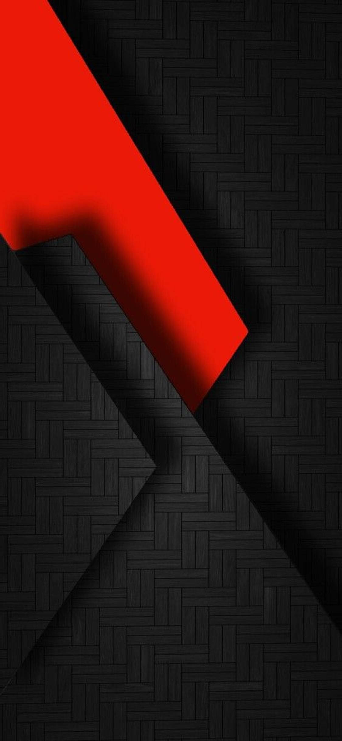 Design 桌布 壁紙 — 一條大膽的紅色斜紋橫跨帶有銳利陰影的紋理黑色編織背景。
