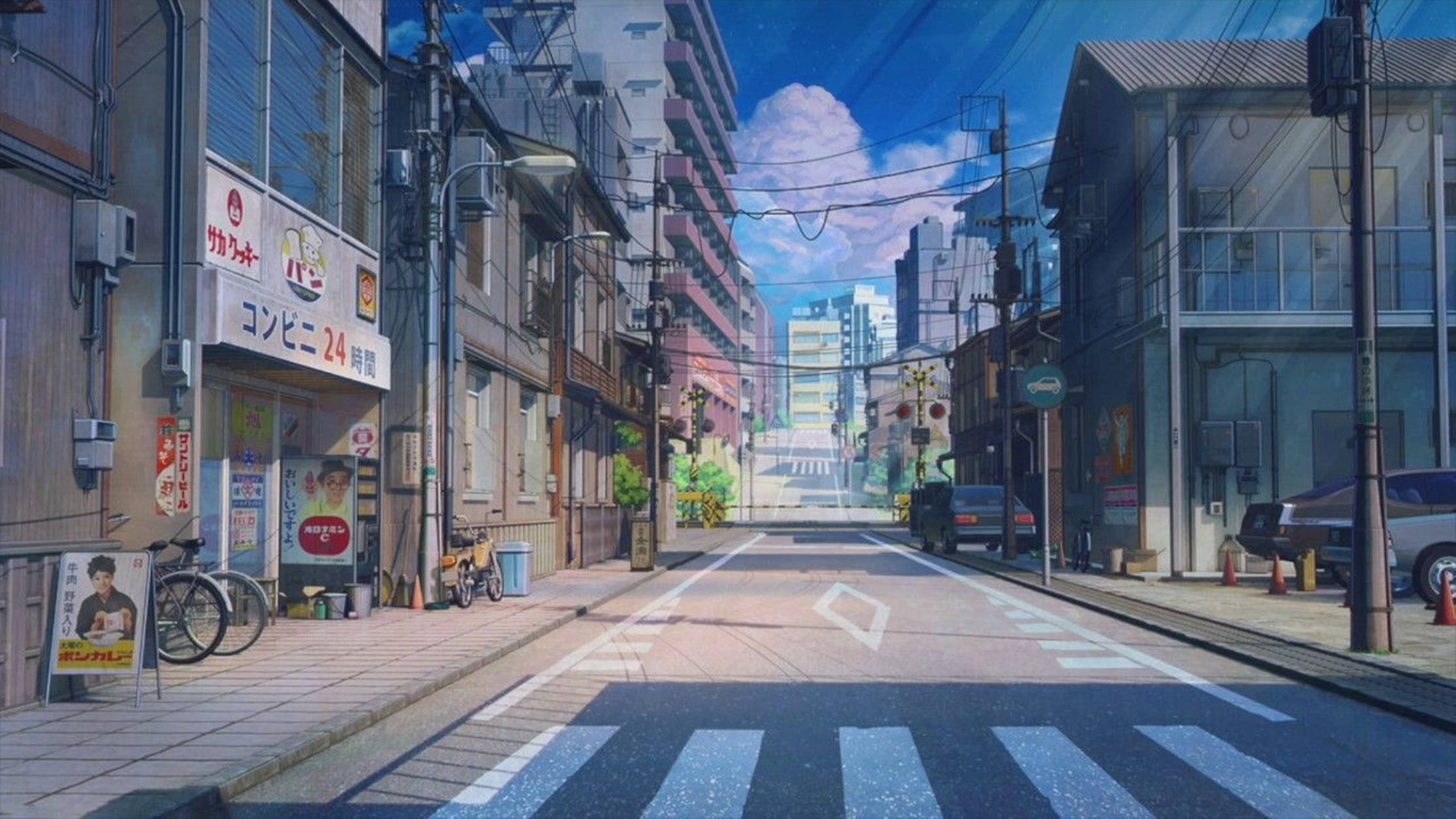 東京 桌布 壁紙 — 一條寧靜的日本街道沐浴在明亮的日光下，兩旁是色彩繽紛的建築物，頭頂是清澈的藍天。