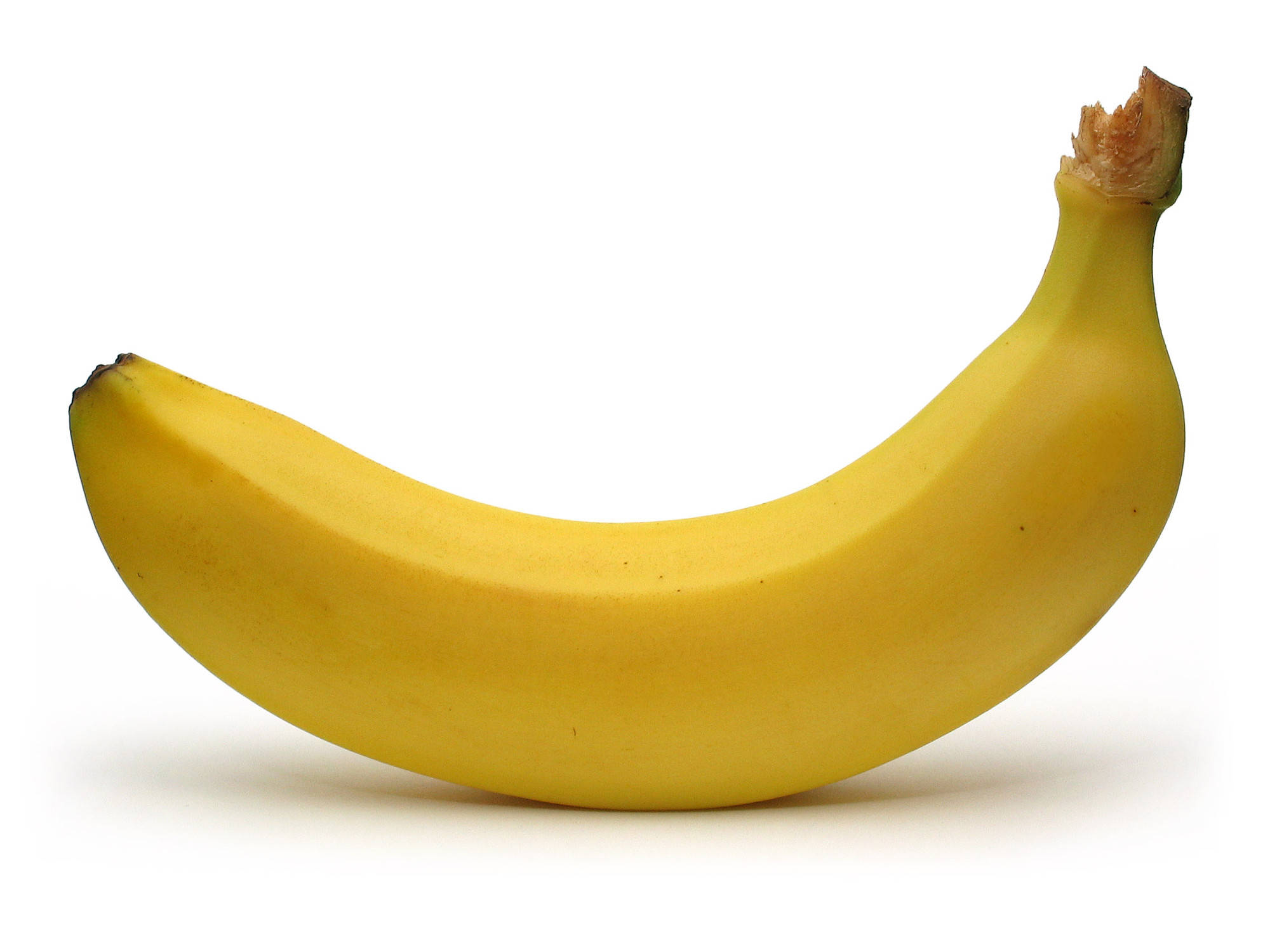 Plantain 桌布 壁紙 — 一條成熟的黃色香蕉在純白背景上優雅彎曲，帶有柔和陰影。