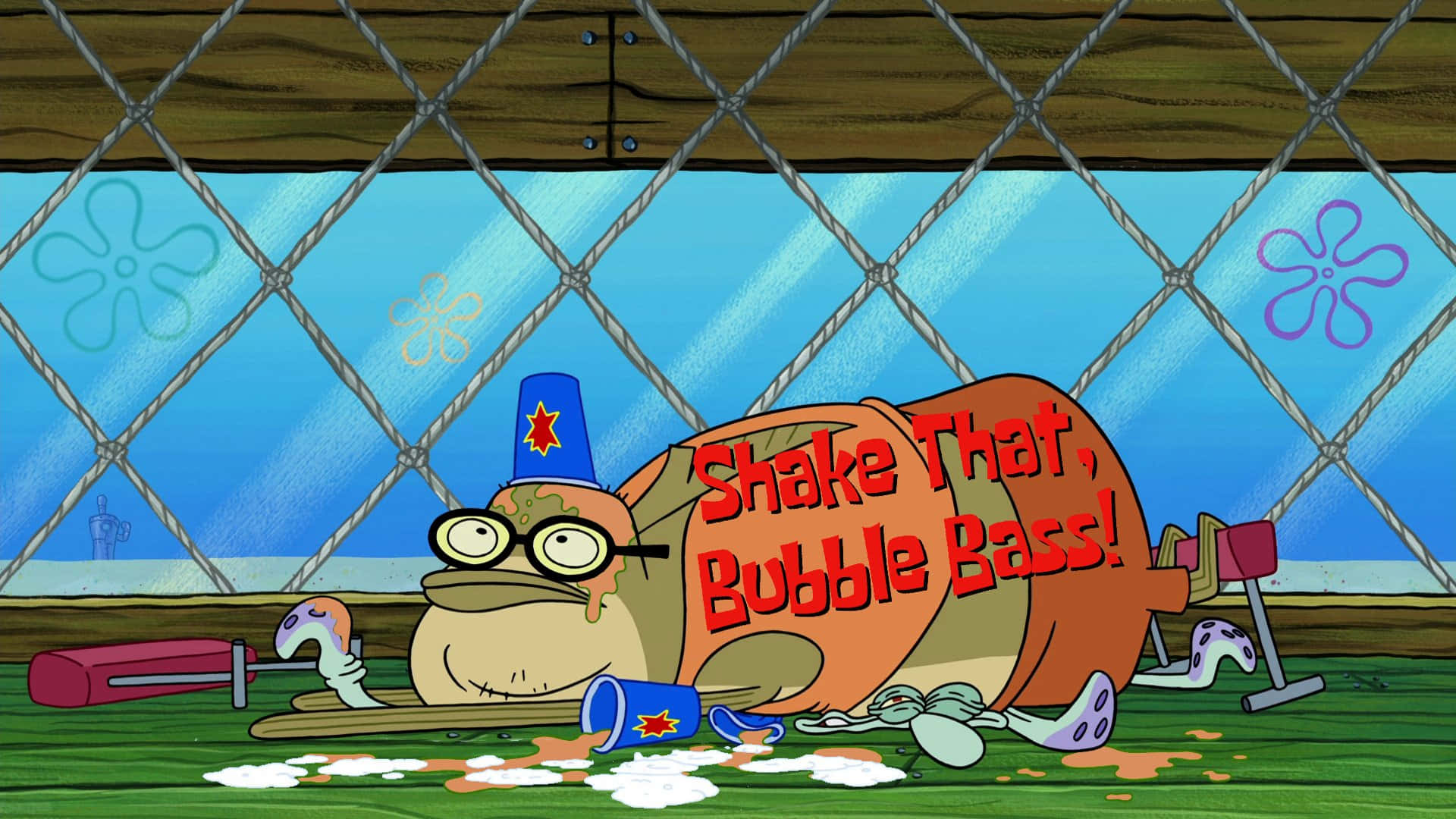 Bubble Bass 桌布 壁紙 — 一條戴著藍色帽子和眼鏡的卡通魚，在一個寫有「Shake That Bubble Bass！」的泡泡低音鼓內休息。
