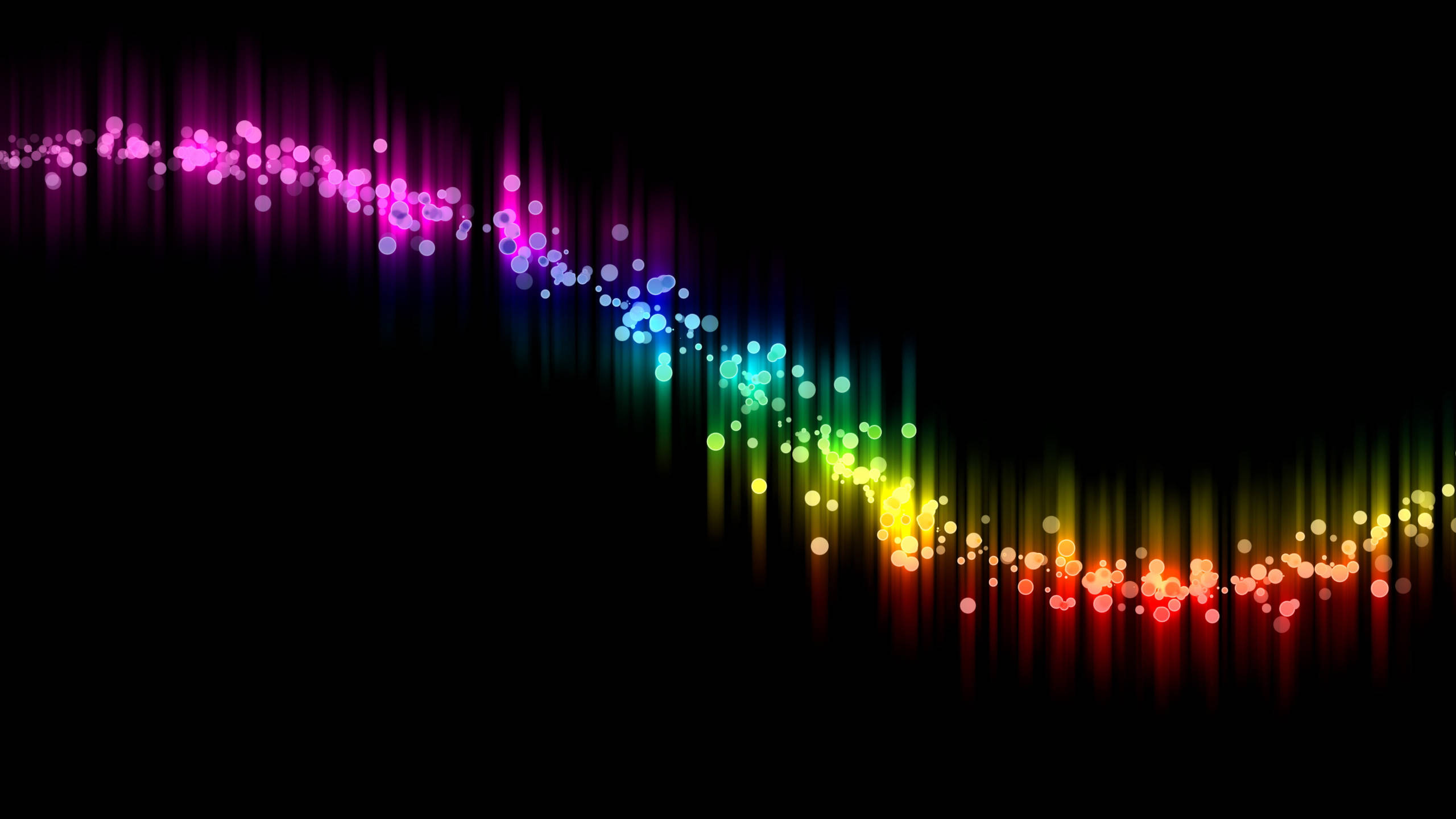 Spectrum 桌布 壁紙 — 一條由發光散景點組成的鮮豔彩虹聲波在黑色背景上脈動。